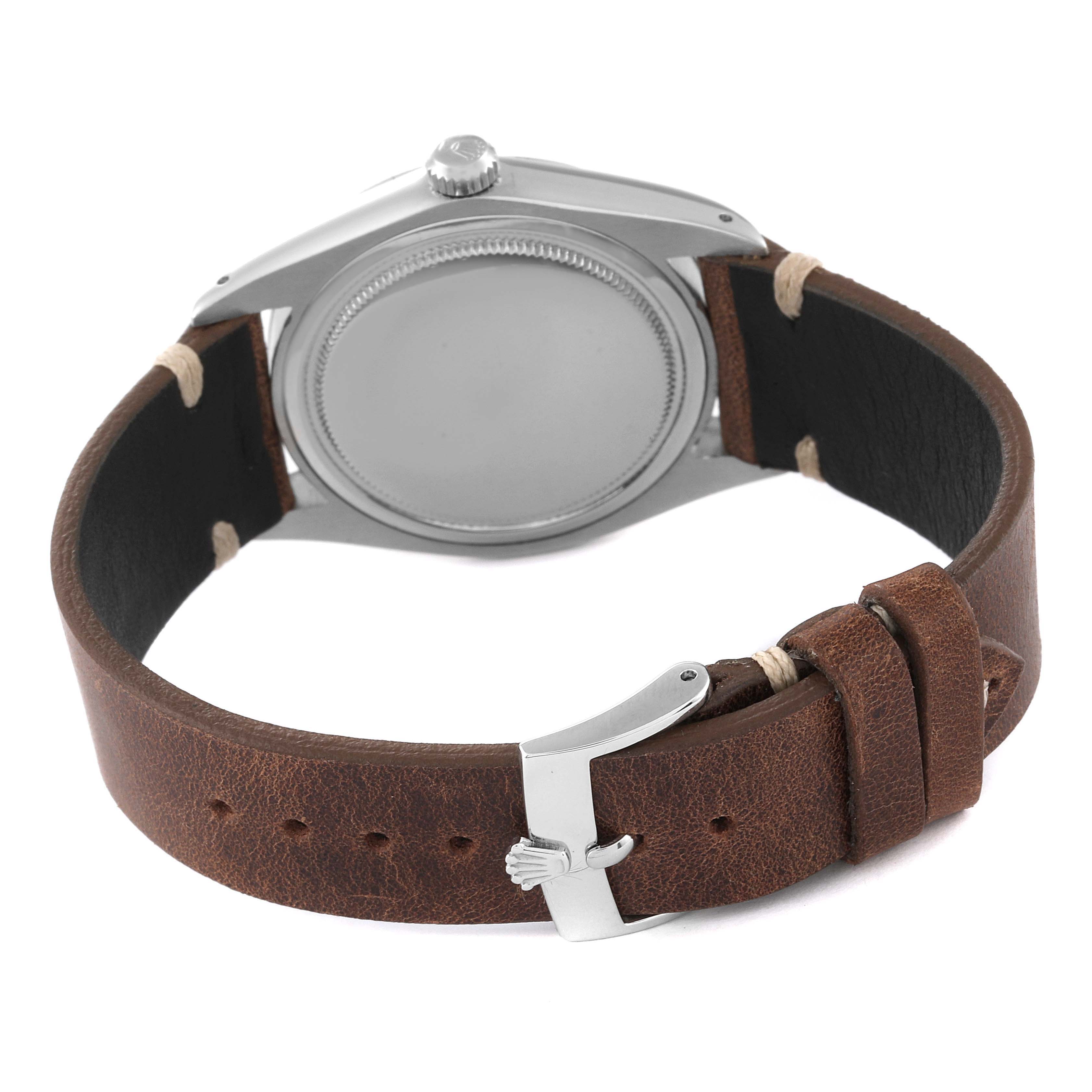 The image shows the back and side view of a Rolex Vintage Collection 6694 Men's Stainless Steel Silver Dial 6694 Men's Stainless Steel Silver Dial model watch, including its case, brown leather strap, and clasp.