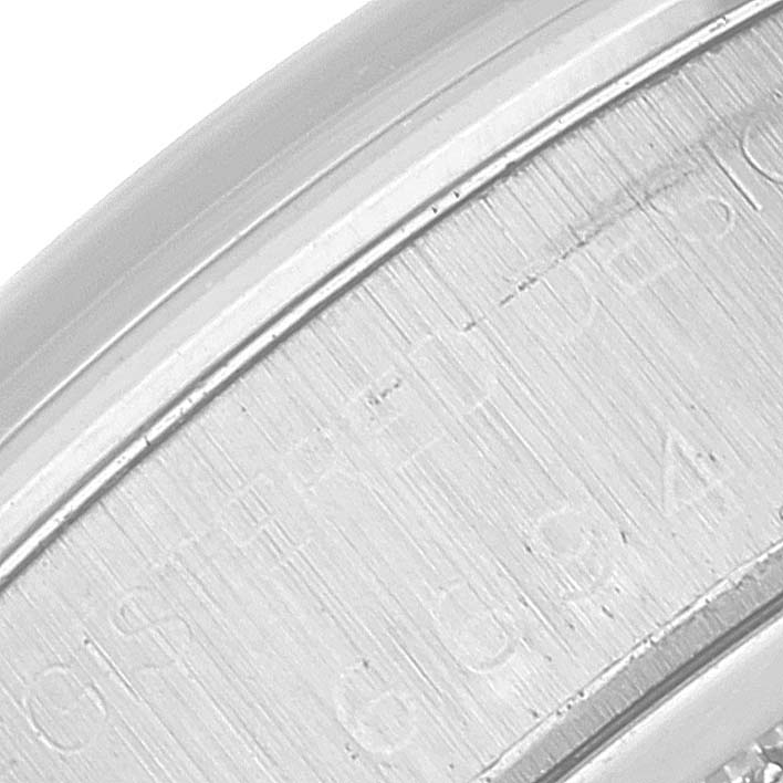 The image shows an extreme close-up of the engraved side of a Rolex Vintage Collection 6694 Men's Stainless Steel Silver Dial 6694 Men's Stainless Steel Silver Dial watch casing.