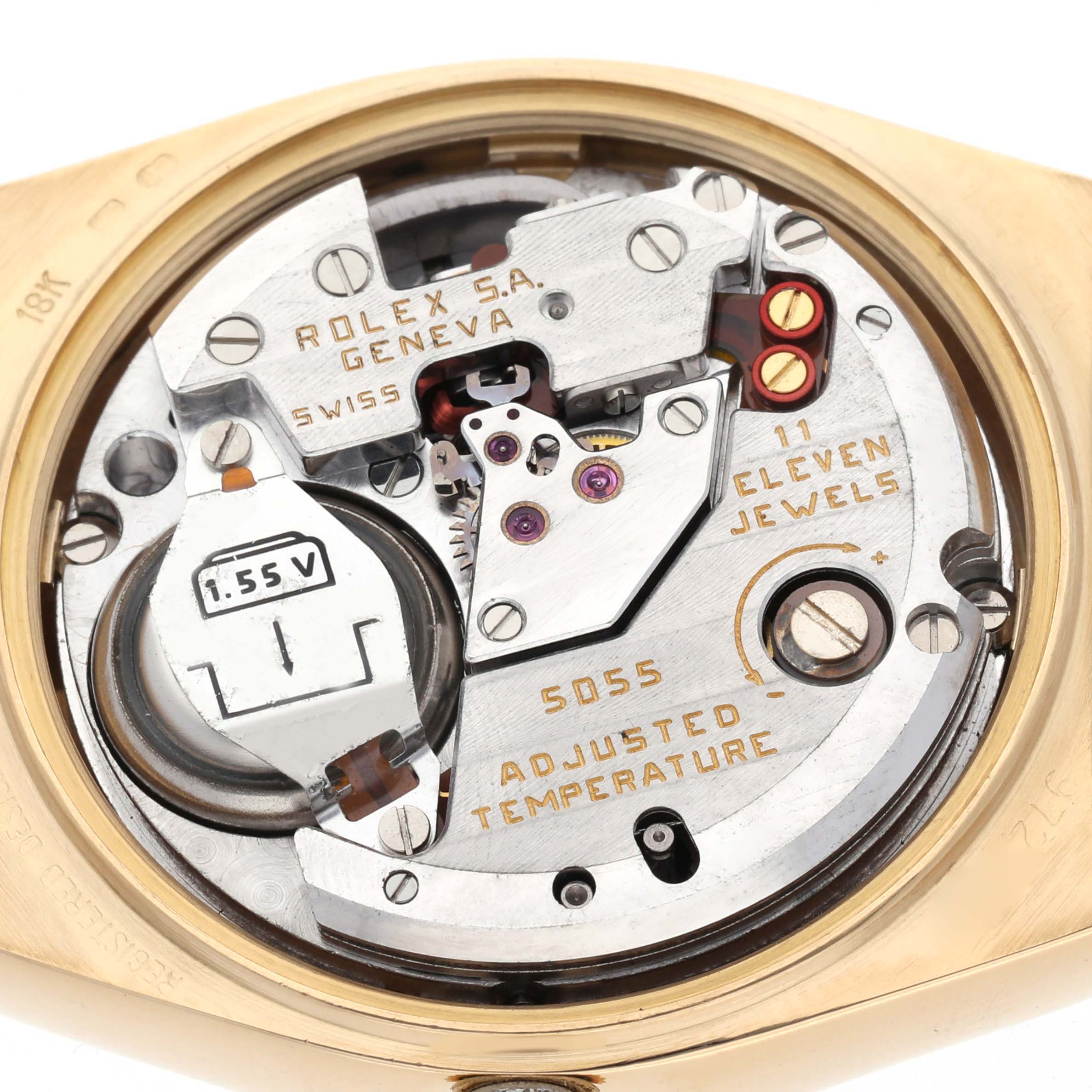 The image shows the movement of a Rolex Oysterquartz 19018 Men's Yellow Gold Champagne Dial 19018 Men's Yellow Gold Champagne Dial, highlighting its internal components and battery from a back angle.