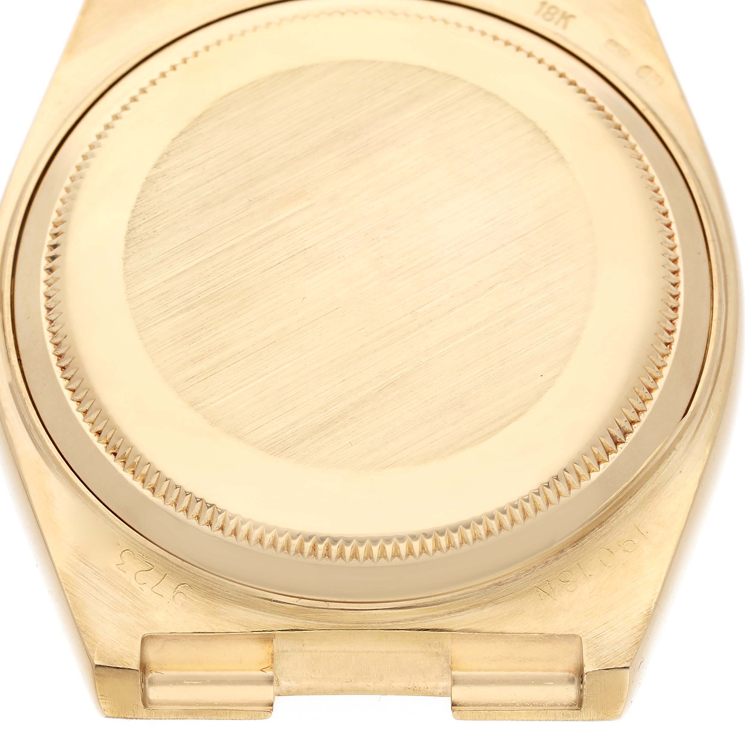 The image shows the back case of a Rolex Oysterquartz 19018 Men's Yellow Gold Champagne Dial 19018 Men's Yellow Gold Champagne Dial watch from a top-down angle, highlighting the grooved edges.