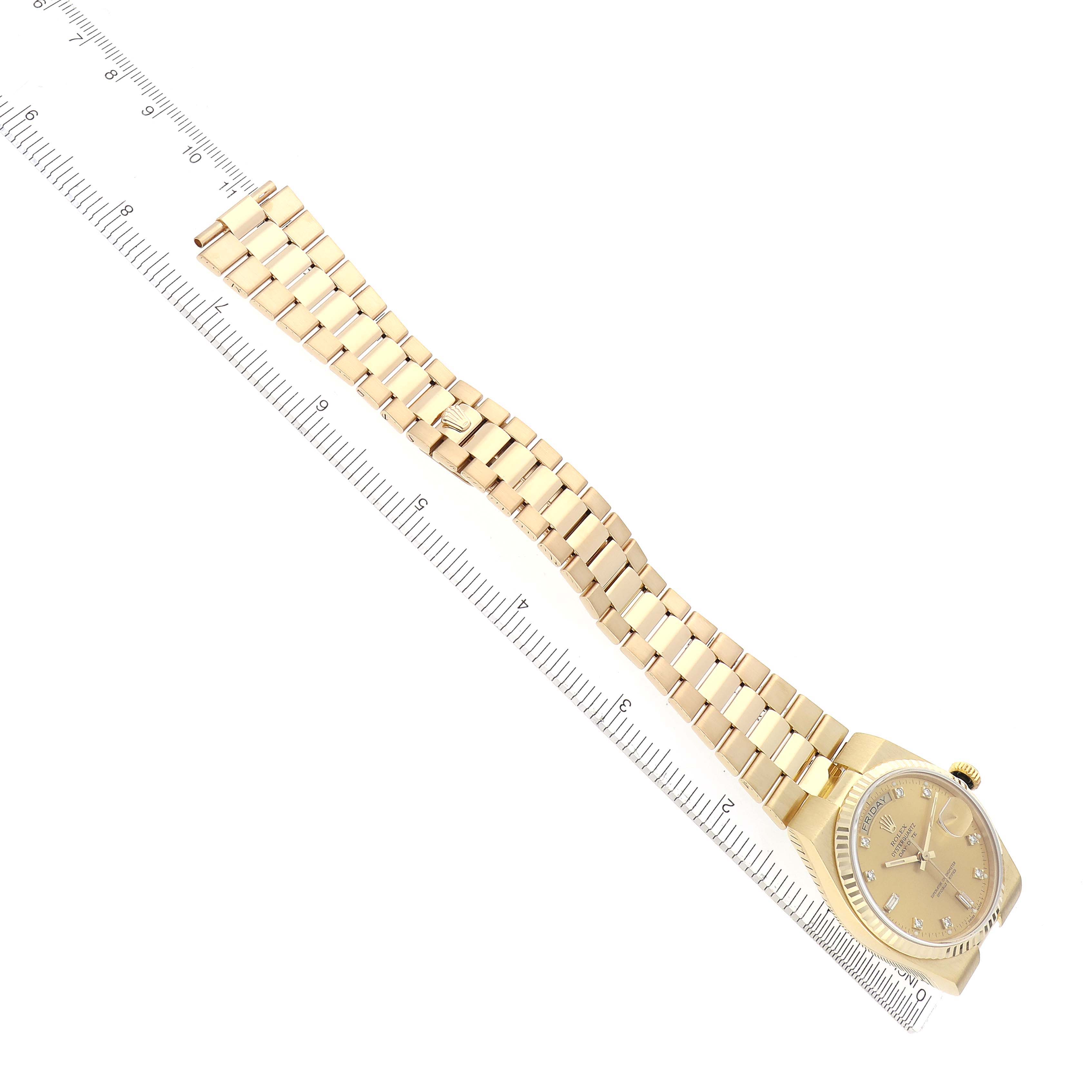 The Rolex Oysterquartz 19018 Men's Yellow Gold Champagne Dial 19018 Men's Yellow Gold Champagne Dial watch is shown at an angled top view, highlighting the face and full metal bracelet.