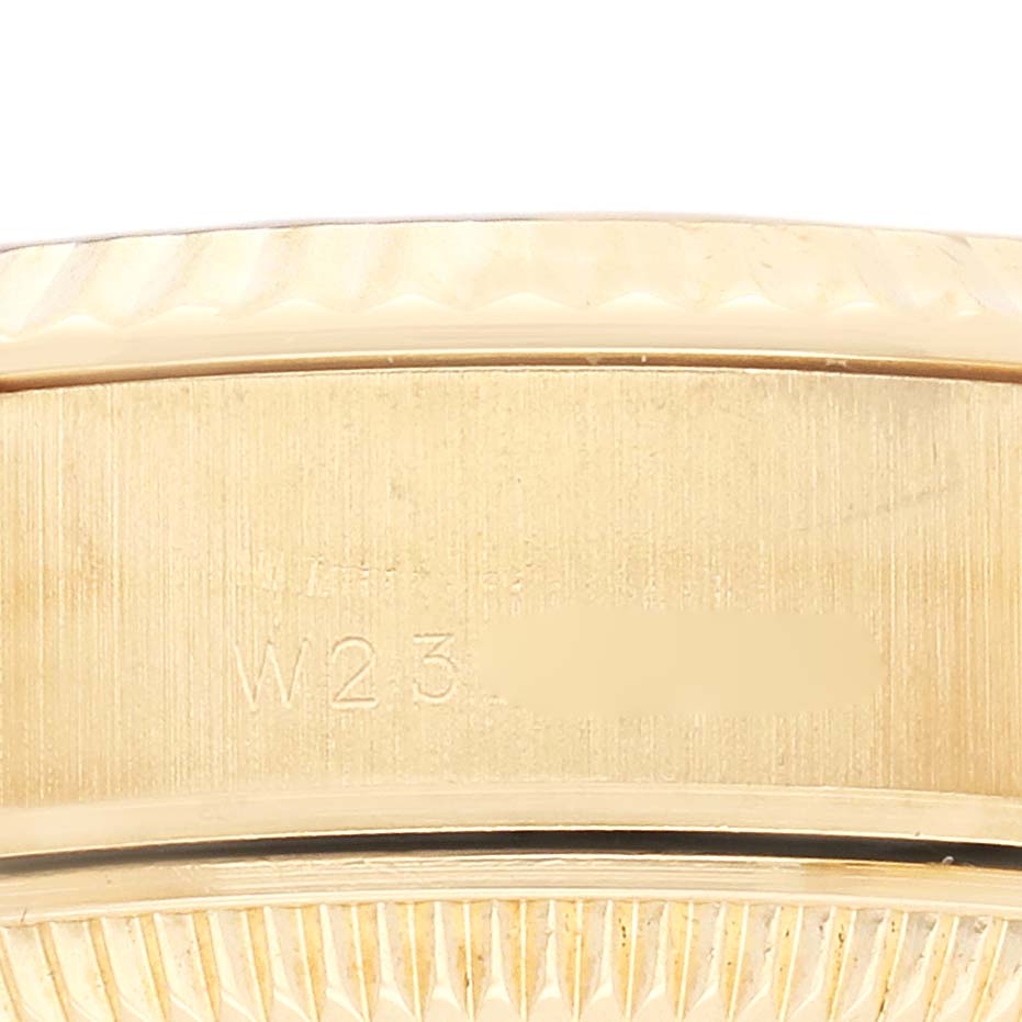 The image shows a close-up of the side of a Rolex President 69178 Women
s Yellow Gold Champagne Dial 69178 Women
s Yellow Gold Champagne Dial watch, focusing on the bracelet links and engraved details.