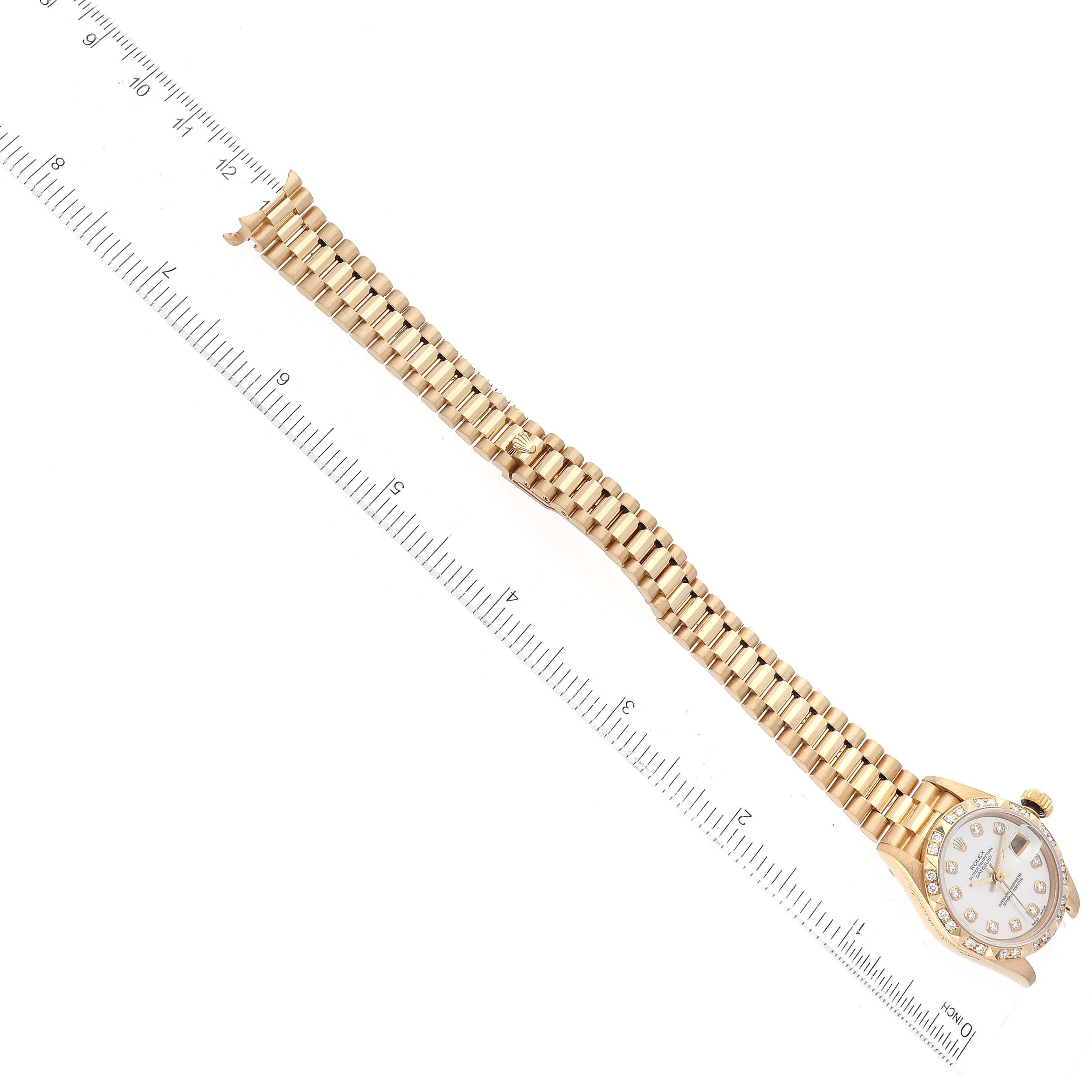 The Rolex President 69258 Women's Yellow Gold Mother of Pearl Dial 69258 Women's Yellow Gold Mother of Pearl Dial watch is shown from a top-down angle, highlighting the bracelet, dial, and crown.