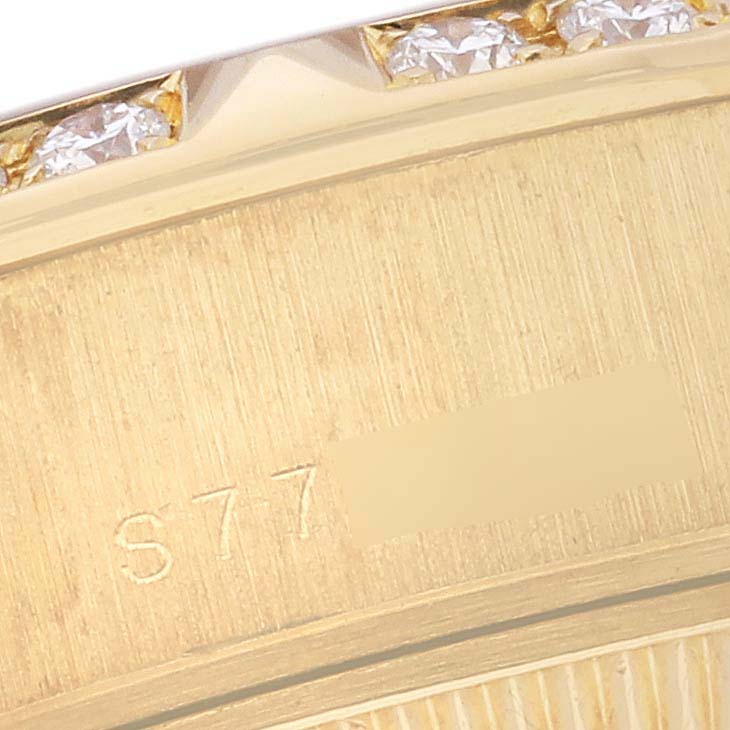 This close-up image shows the engraved side of the bezel on a Rolex President 69258 Women's Yellow Gold Mother of Pearl Dial 69258 Women's Yellow Gold Mother of Pearl Dial model watch, with diamond details visible.