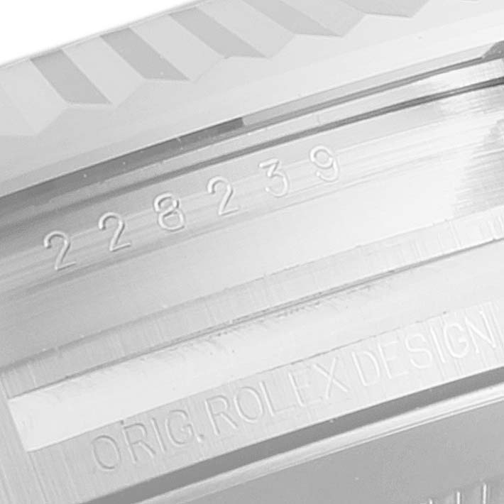 This close-up image shows the engraved serial number and "ORIG. ROLEX DESIGN" inscription on the Rolex President 228239 Men's White Gold Green Dial 228239 Men's White Gold Green Dial model watch.