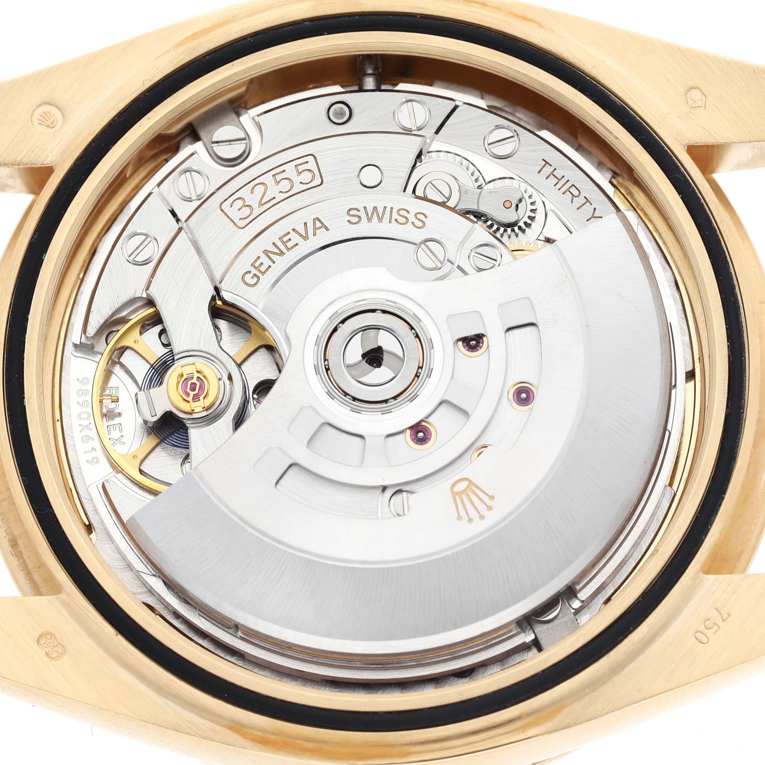 The image shows the internal movement of a Rolex President 228348 Men's Yellow Gold Champagne Dial watch with the rotor and various gears visible.