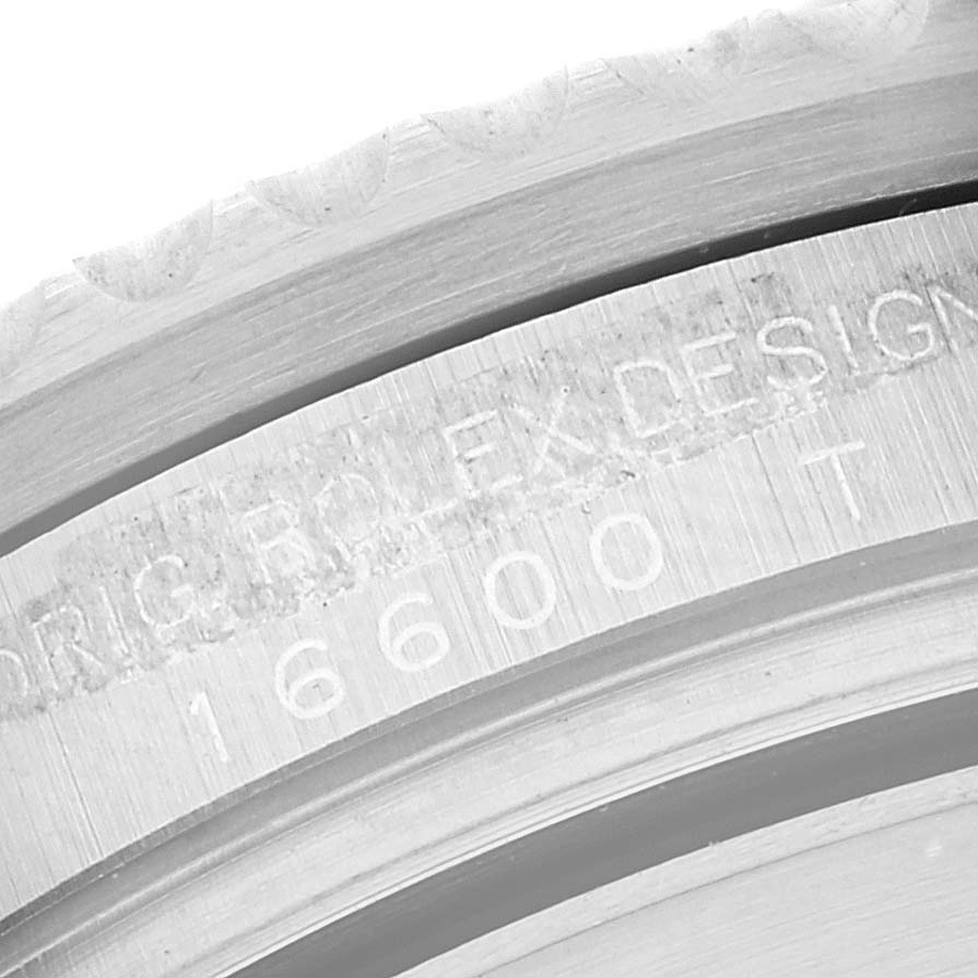 This close-up image of the Rolex Sea-Dweller 16600 Men
s Stainless Steel Black Dial 16600 Men
s Stainless Steel Black Dial watch shows the engraved model number and part of the bezel.