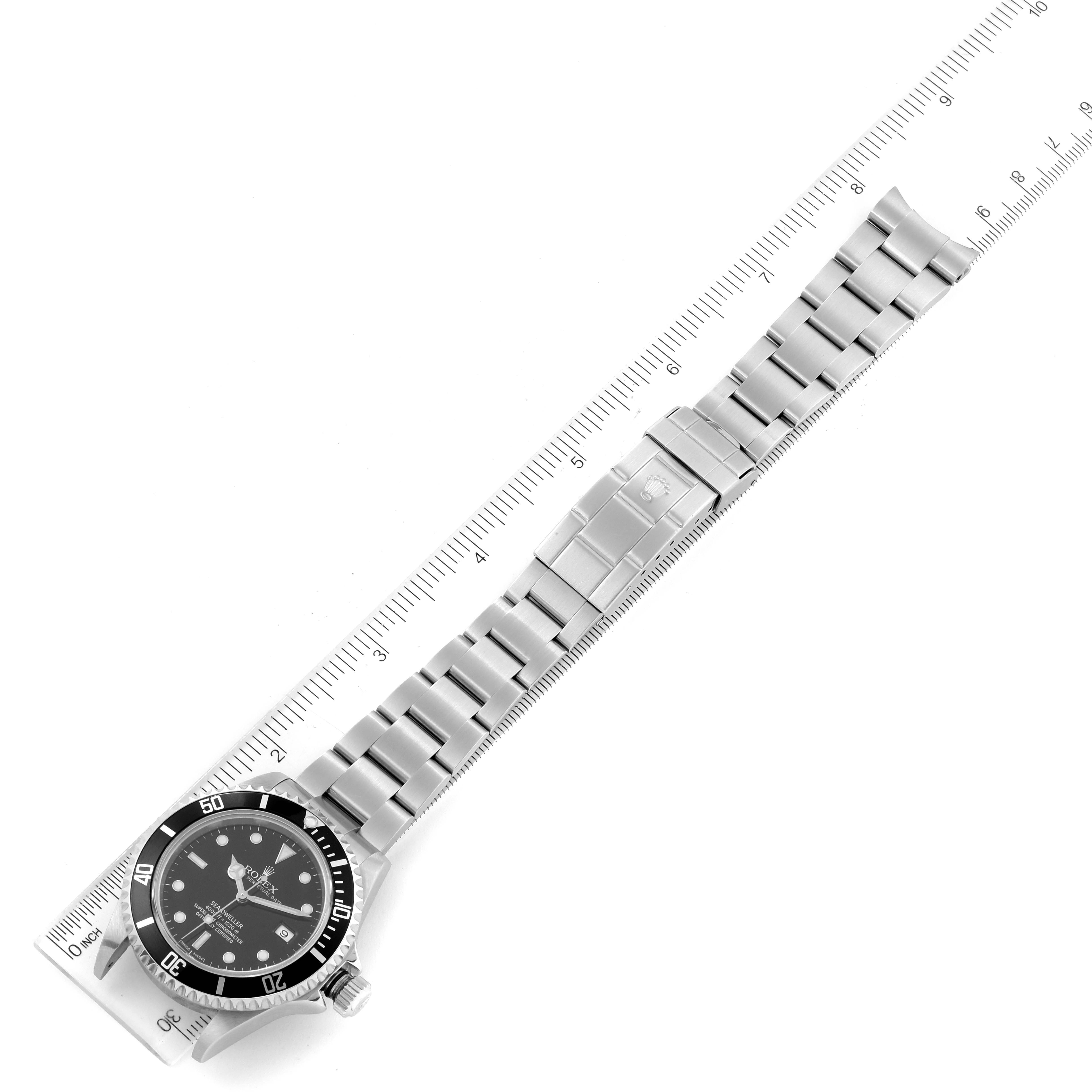 The image shows a top-down view of a Rolex Sea-Dweller 16600 Men
s Stainless Steel Black Dial 16600 Men
s Stainless Steel Black Dial watch with a full bracelet laid alongside a ruler.