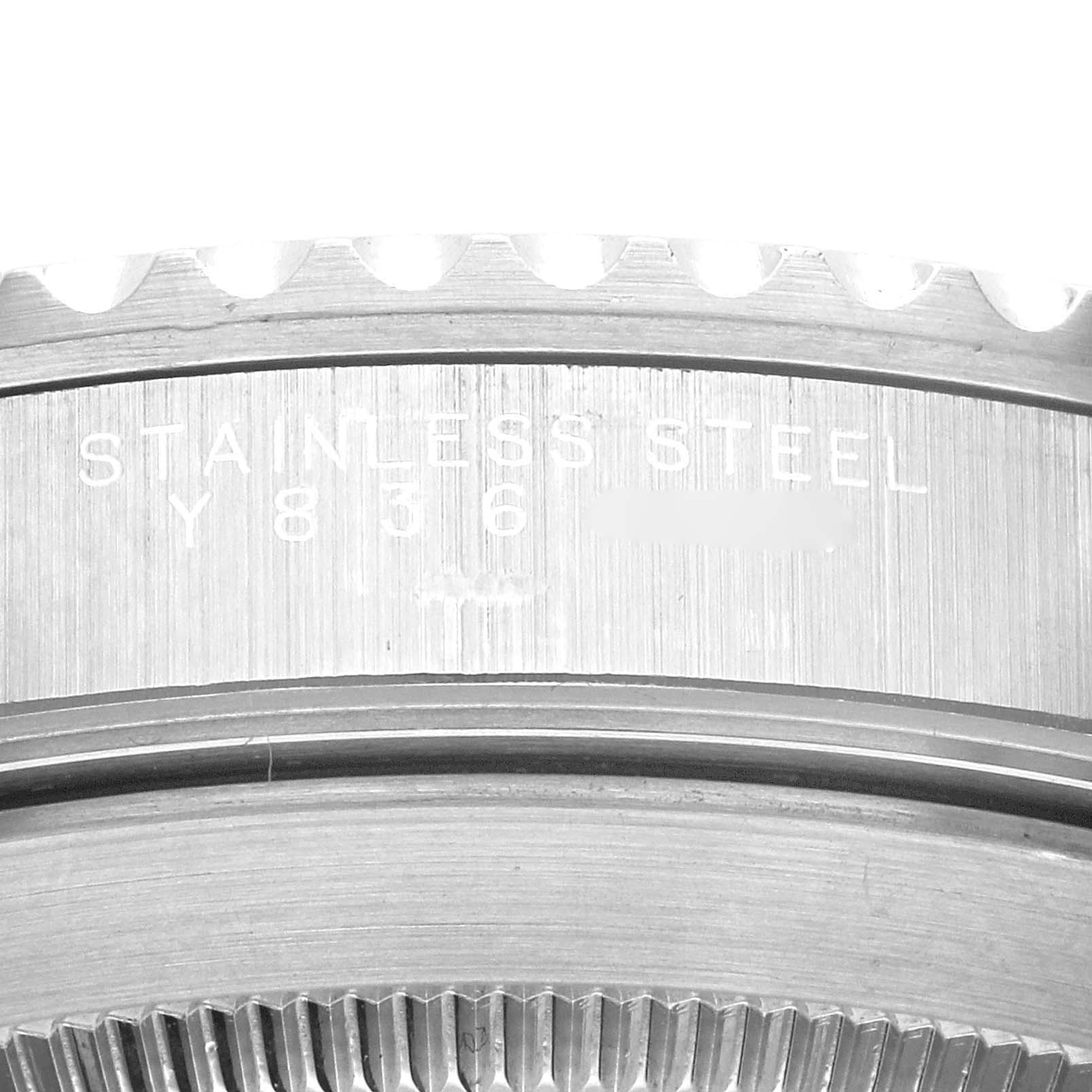 This image shows a close-up of the etched 'Stainless Steel' text and serial number on the case back of a Rolex Submariner 14060 Men's Stainless Steel Black Dial 14060 Men's Stainless Steel Black Dial watch.