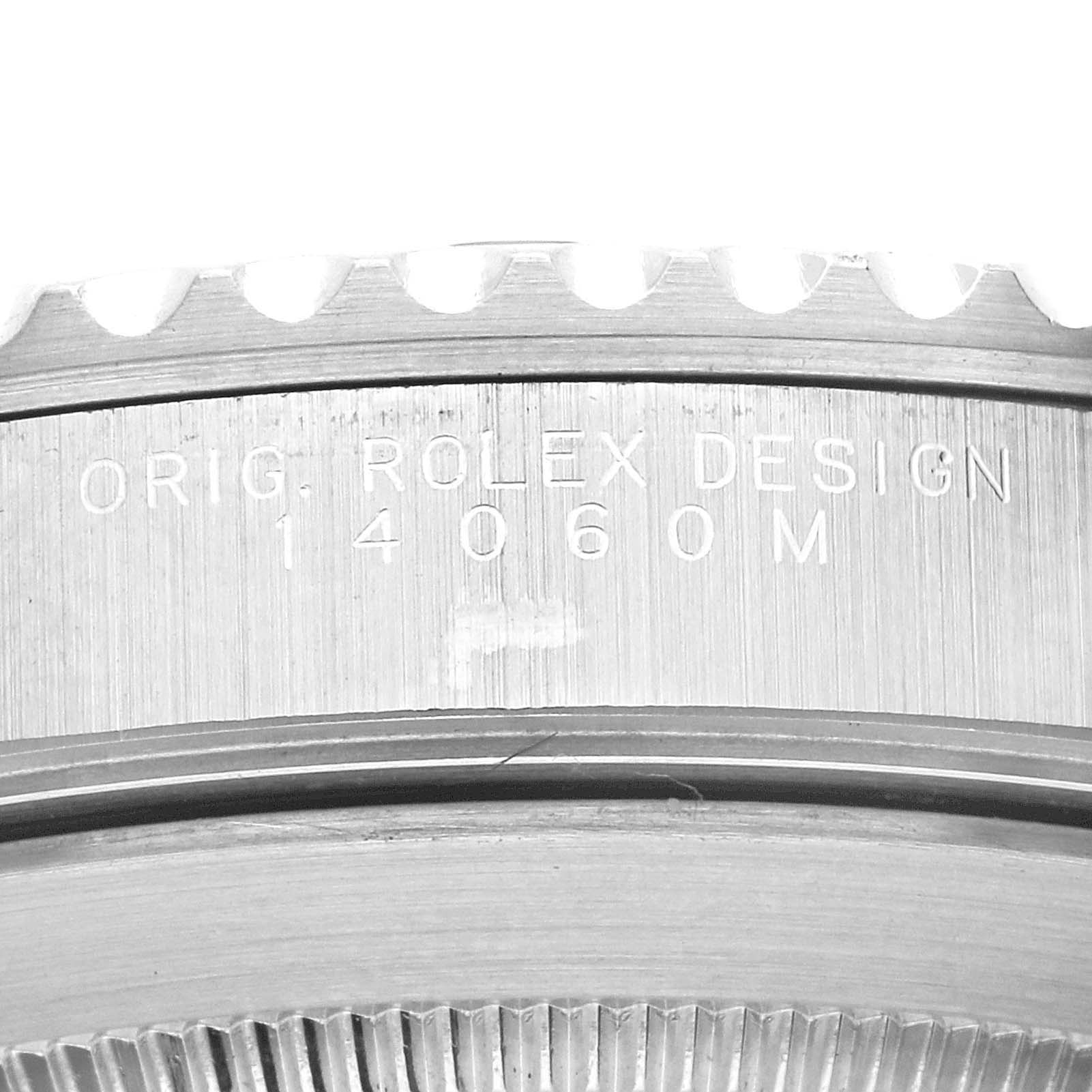 The image shows a close-up of the case and bezel of the Rolex Submariner 14060 Men's Stainless Steel Black Dial 14060 Men's Stainless Steel Black Dial model, highlighting the engraved design number.