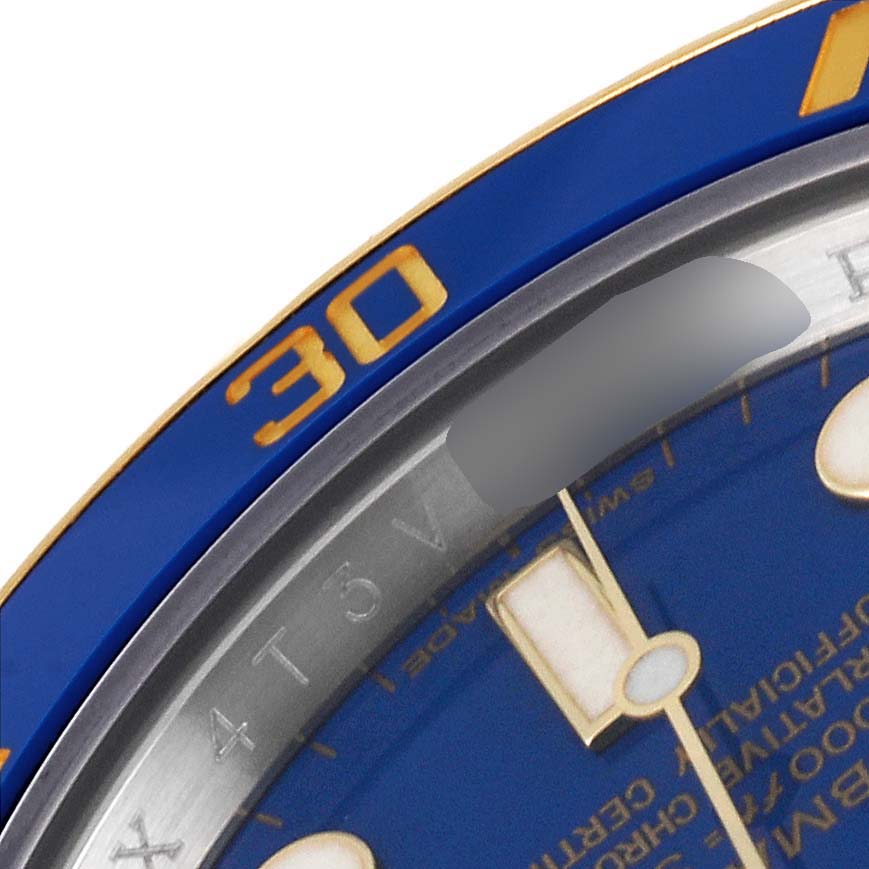The image shows a close-up of the bezel and part of the dial of a Rolex Submariner 116613 Men's Steel and Gold (two tone) Blue Dial 116613 Men's Steel and Gold (two tone) Blue Dial watch, focusing on the 30-minute mark.