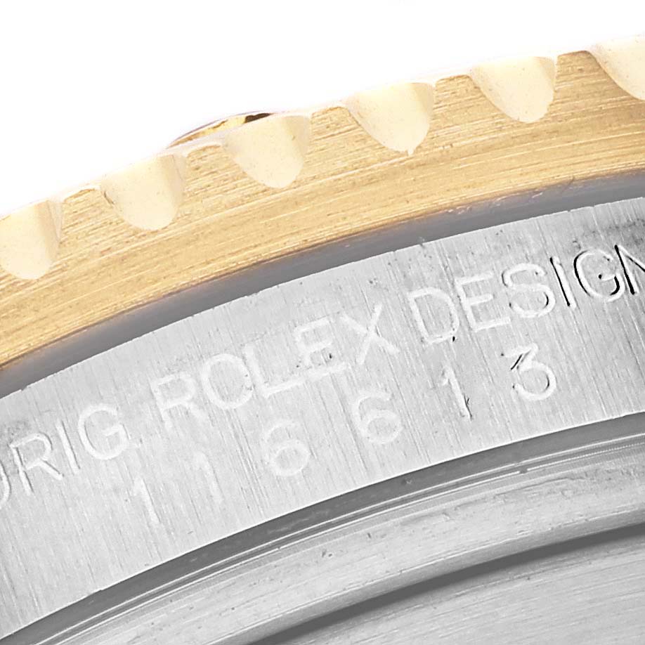 This close-up image shows the engraved side of the bezel and case of a Rolex Submariner 116613 Men's Steel and Gold (two tone) Blue Dial 116613 Men's Steel and Gold (two tone) Blue Dial watch, highlighting the model number.