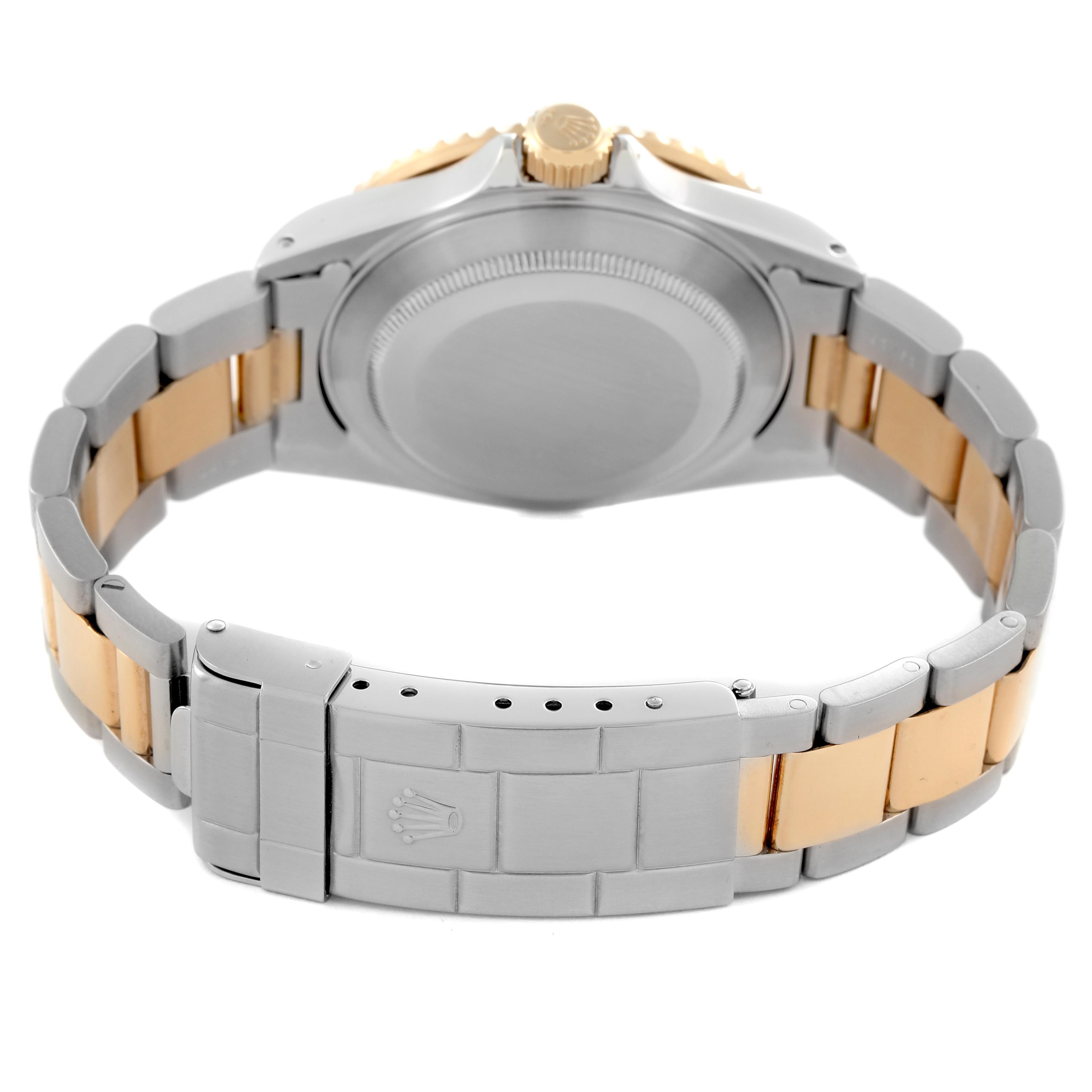 The Rolex Submariner 16613 Men's Steel and Gold (two tone) Silver Dial 16613 Men's Steel and Gold (two tone) Silver Dial is shown from the back, featuring the clasp, case back, and bracelet links in a two-tone design.