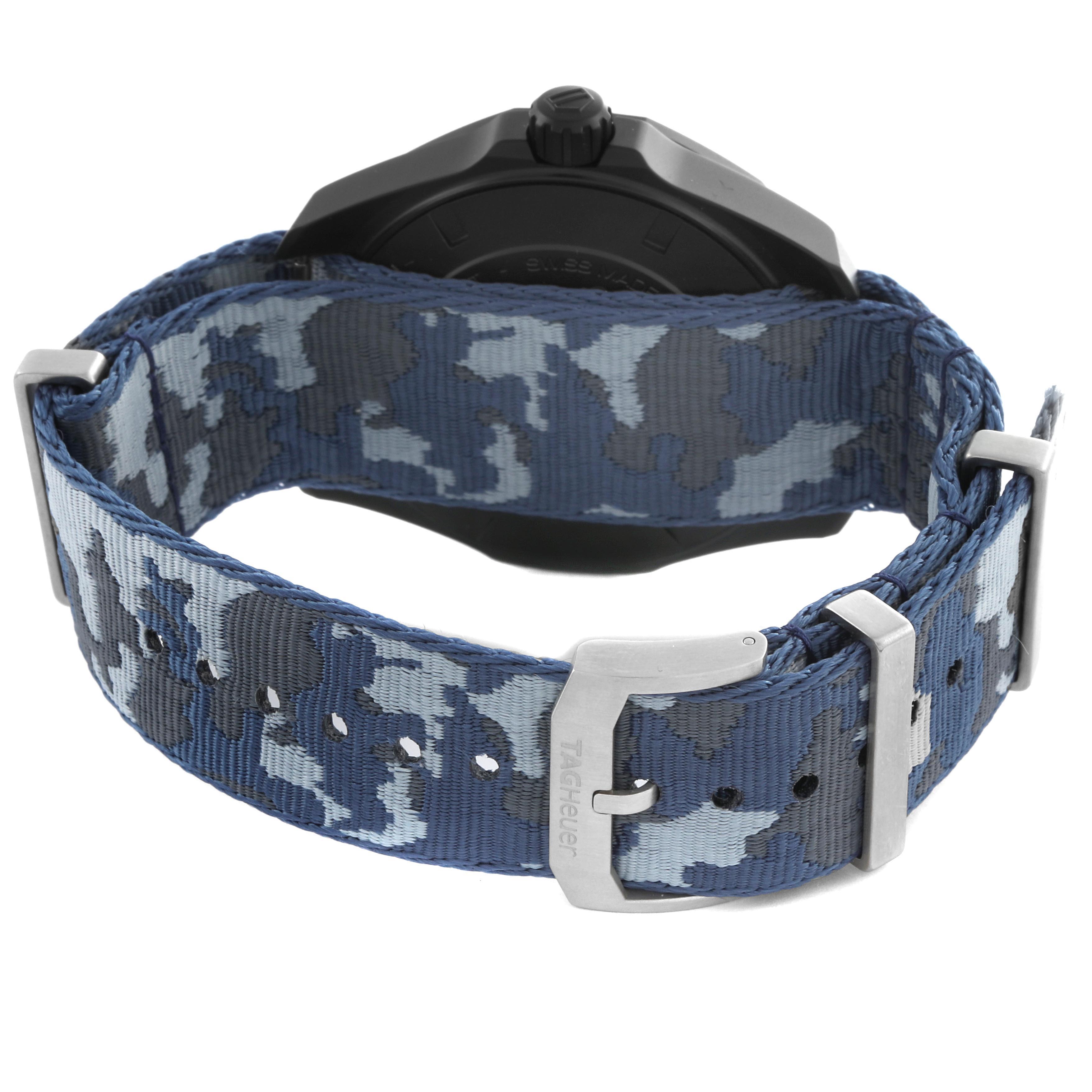 The image shows the back of a Tag Heuer Aquaracer WAY208D.FC8221 Men
s Titanium Blue Dial WAY208D.FC8221 Men
s Titanium Blue Dial watch, highlighting a blue camo-patterned nylon strap with a metal buckle.