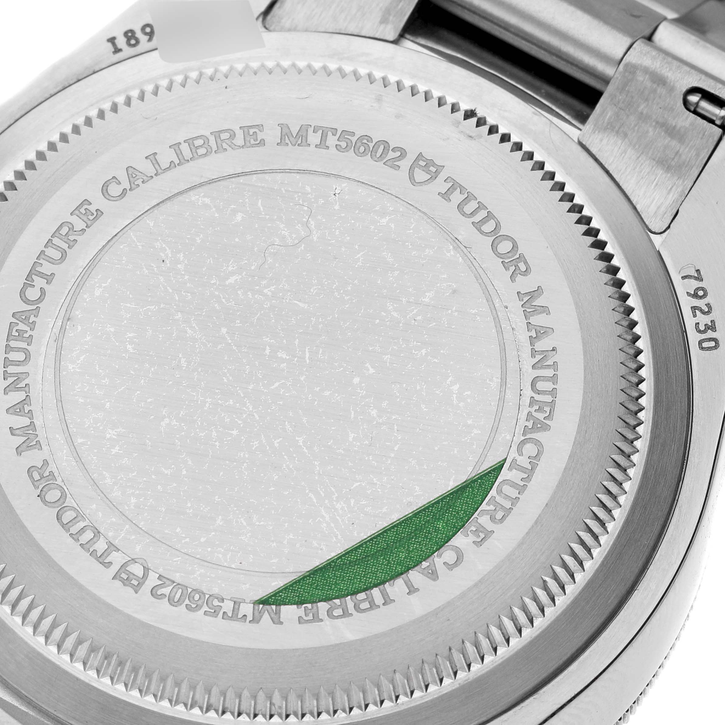 The image shows the back case of a Tudor Heritage Black Bay 79230R Men
s Stainless Steel Black Dial 79230R Men
s Stainless Steel Black Dial watch, highlighting the "TUDOR MANUFACTURE CALIBRE MT5602" and model number.