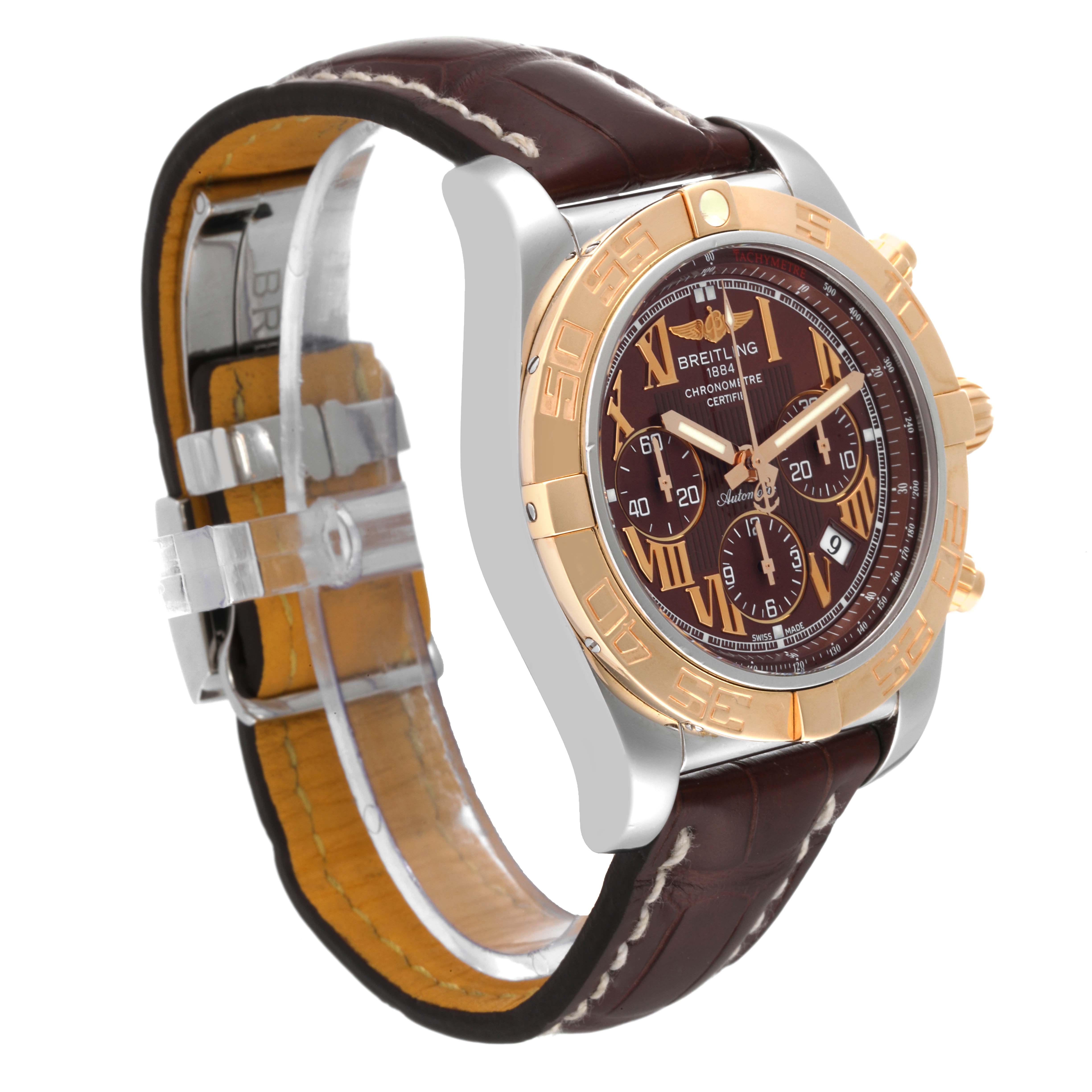 The image shows a side angle view of the Breitling Chronomat CB0110 Men's Steel and Gold (two tone) Brown Dial CB0110 Men's Steel and Gold (two tone) Brown Dial watch, highlighting its face, bezel, and leather strap.