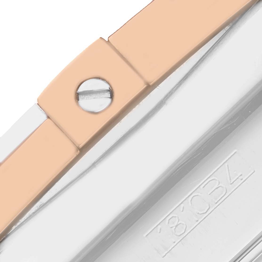 This close-up image of the Breitling Chronomat CB0110 Men's Steel and Gold (two tone) Brown Dial CB0110 Men's Steel and Gold (two tone) Brown Dial watch shows part of the bracelet and a screw along with an engraved model number.