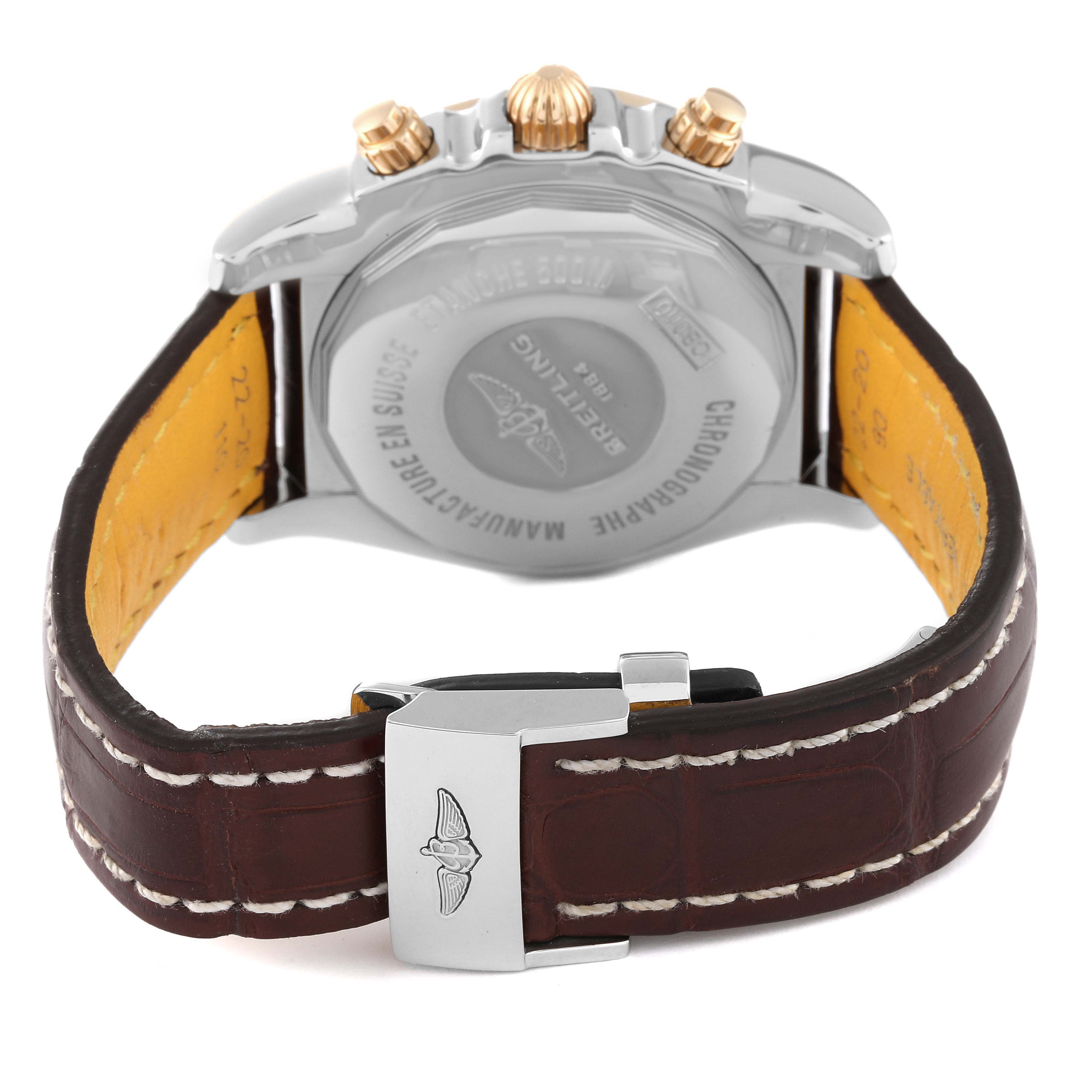 The image shows the back view of the Breitling Chronomat CB0110 Men's Steel and Gold (two tone) Brown Dial CB0110 Men's Steel and Gold (two tone) Brown Dial watch, highlighting the case back, crown, and leather strap with stitching.
