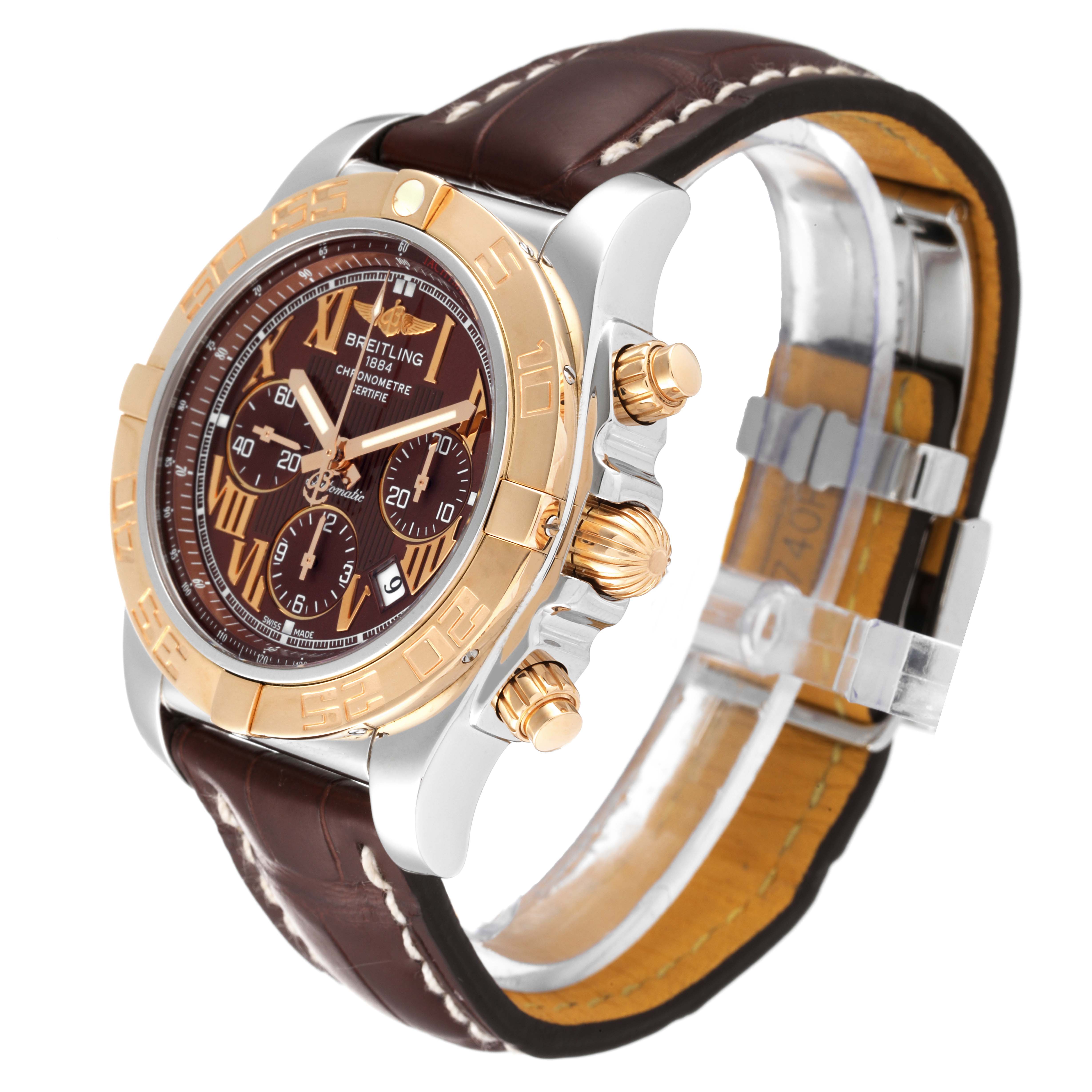 This Breitling Chronomat CB0110 Men's Steel and Gold (two tone) Brown Dial CB0110 Men's Steel and Gold (two tone) Brown Dial watch is shown at an angled close-up, highlighting the dial, bezel, crown, pushers, and leather strap.