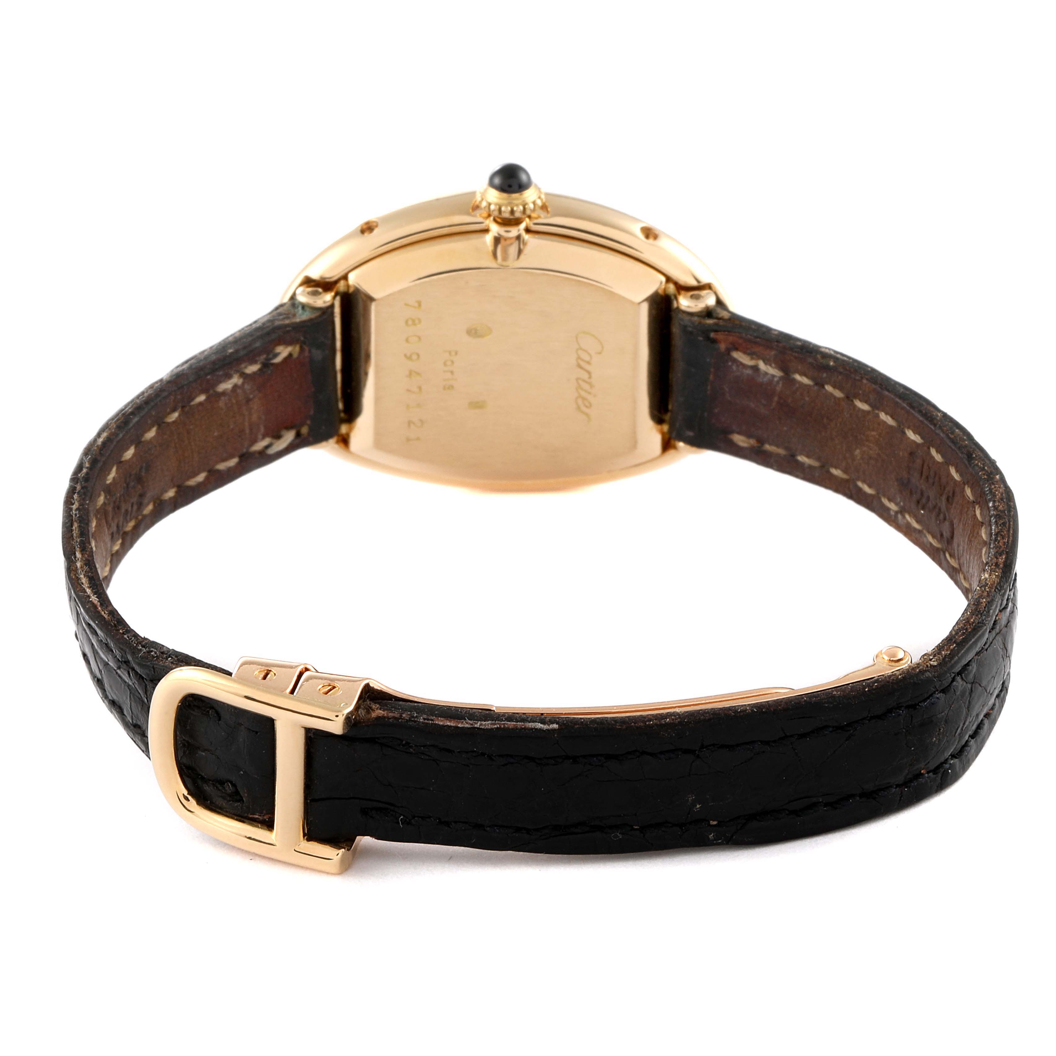 The image shows the back view of a Cartier Baignoire Women's Yellow Gold White Dial Women's Yellow Gold White Dial watch, highlighting its strap, buckle, and case back.