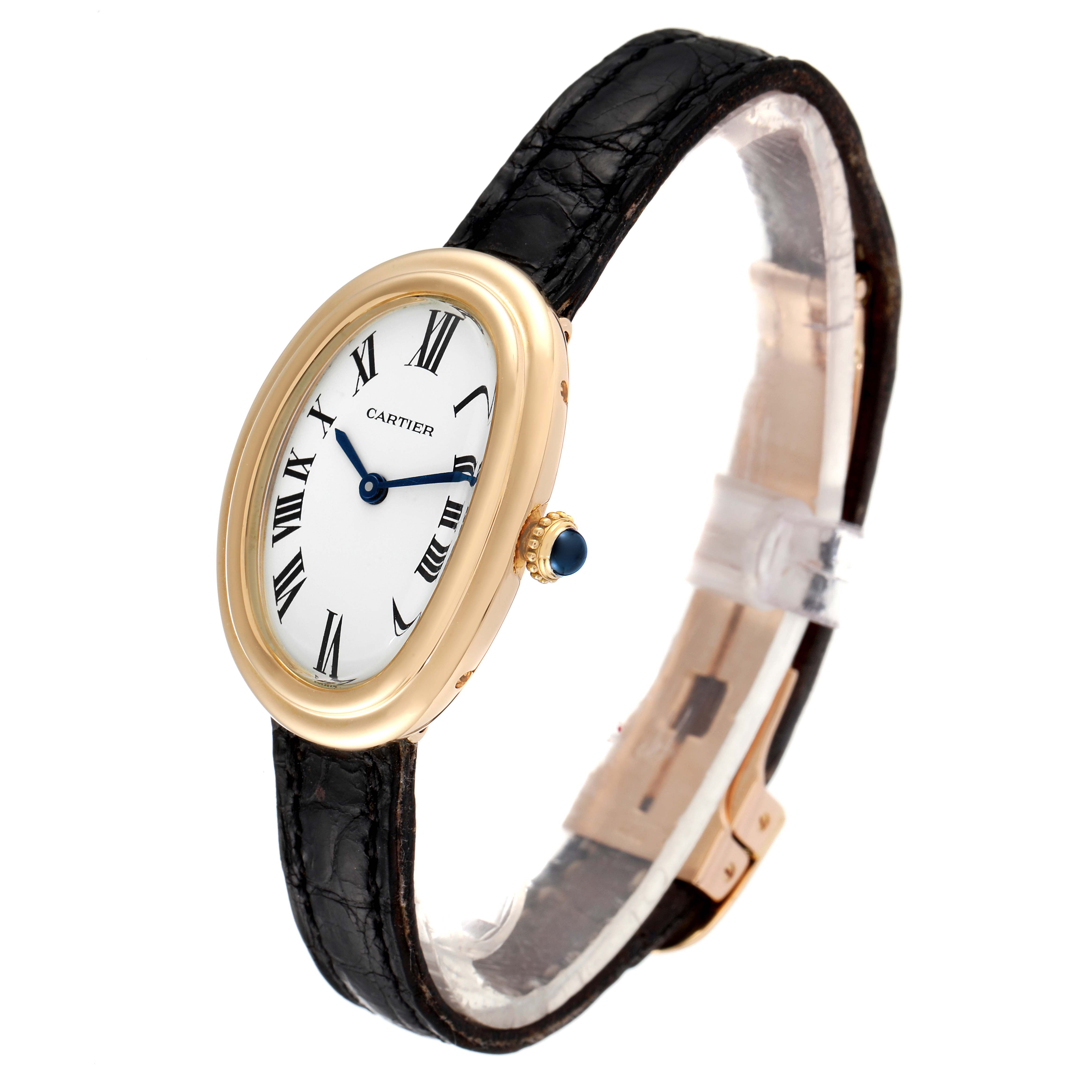 The Cartier Baignoire Women's Yellow Gold White Dial Women's Yellow Gold White Dial watch is shown at a slight angle, highlighting its oval face, gold case, black strap, and blue crown gem.