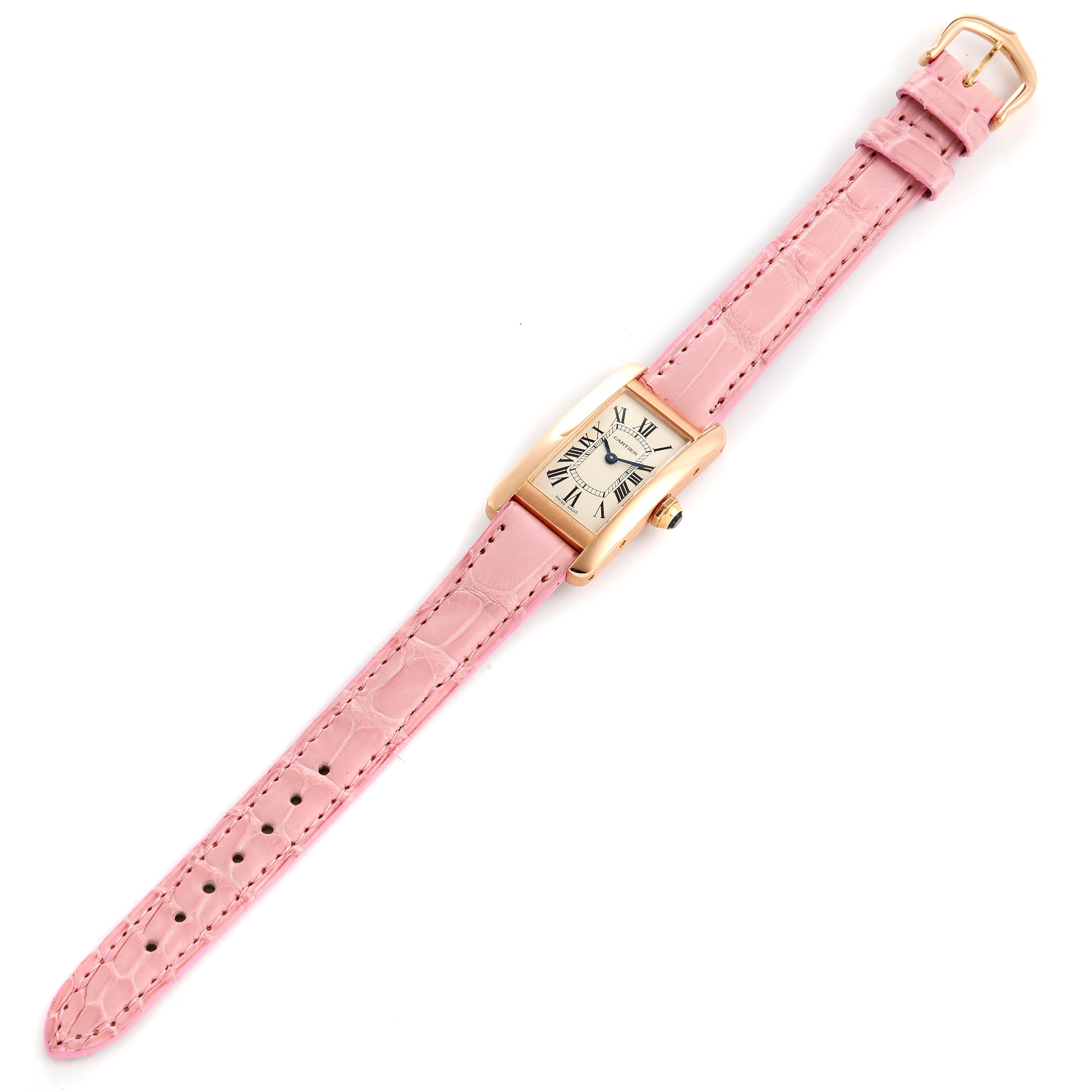 The image shows a top view of a pink-strapped Cartier Tank Americaine W2607456 Women's Rose Gold Silver Dial W2607456 Women's Rose Gold Silver Dial watch, displaying its rectangular face and gold casing.