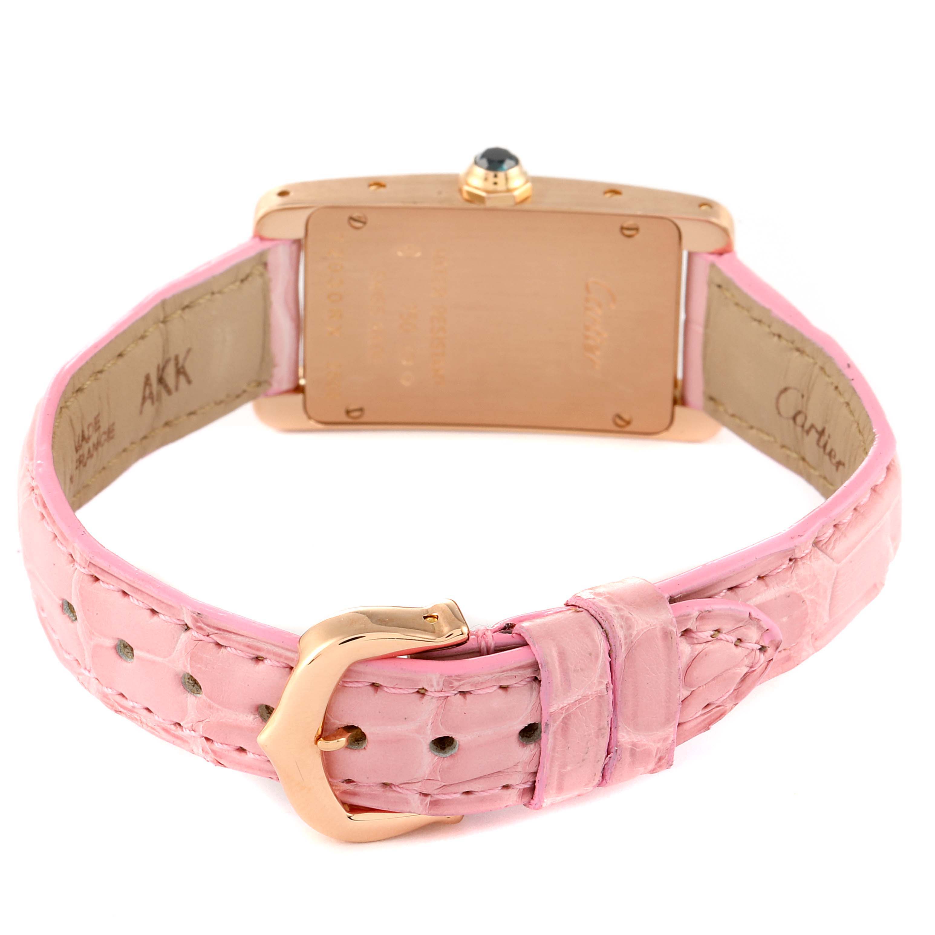 This image shows the back view of a Cartier Tank Americaine W2607456 Women's Rose Gold Silver Dial W2607456 Women's Rose Gold Silver Dial watch, highlighting its pink leather strap and gold buckle.