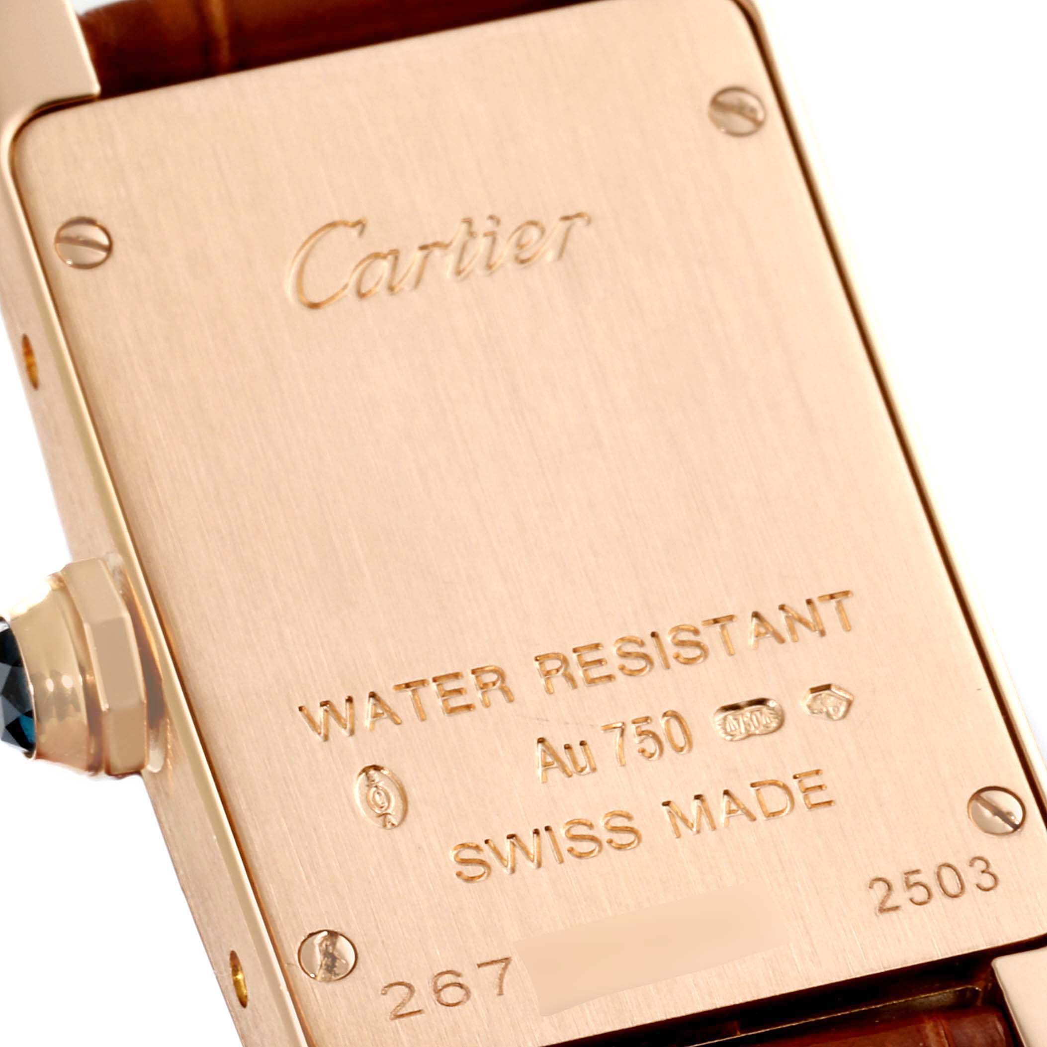 The image shows the backplate of a Cartier Tank Americaine W2607456 Women's Rose Gold Silver Dial W2607456 Women's Rose Gold Silver Dial watch, highlighting its engravings and water resistance details.