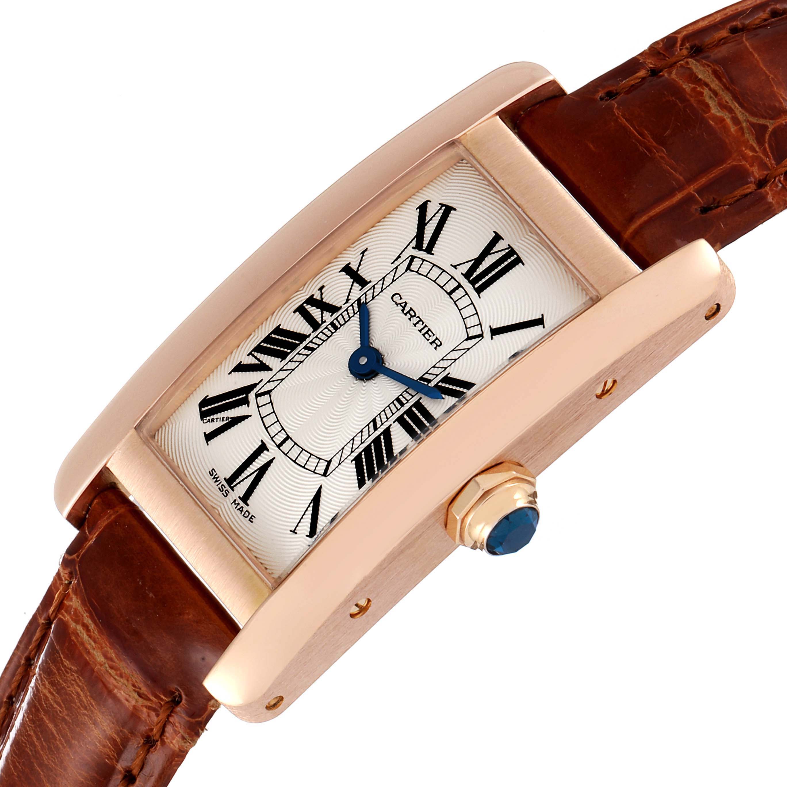 The Cartier Tank Americaine W2607456 Women's Rose Gold Silver Dial W2607456 Women's Rose Gold Silver Dial watch is shown at an angle highlighting its face, case, crown, and brown leather strap.