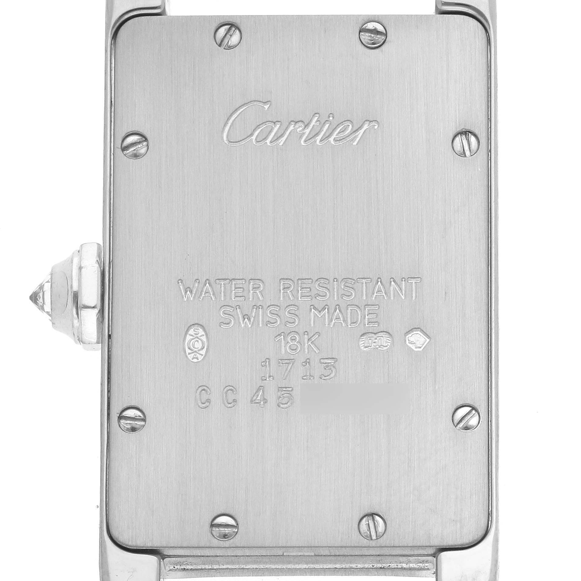 The image shows the back case of a Cartier Tank Américaine watch, highlighting brand markings and specifications.