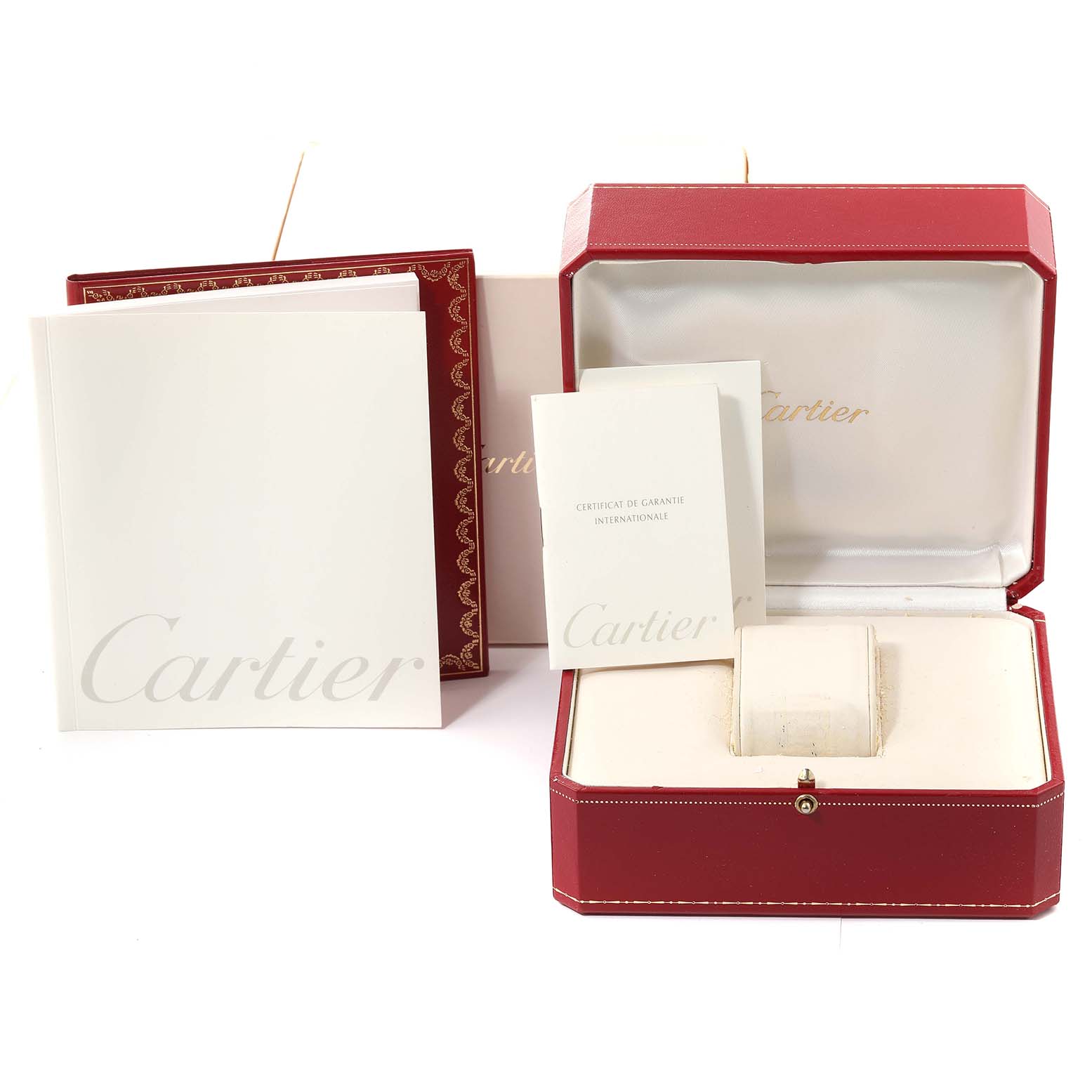 The image shows the Cartier Tank Americaine WB701851 Women's White Gold Silver Dial WB701851 Women's White Gold Silver Dial watch accessories, including a red case, booklets, and a storage box, from a front angle.