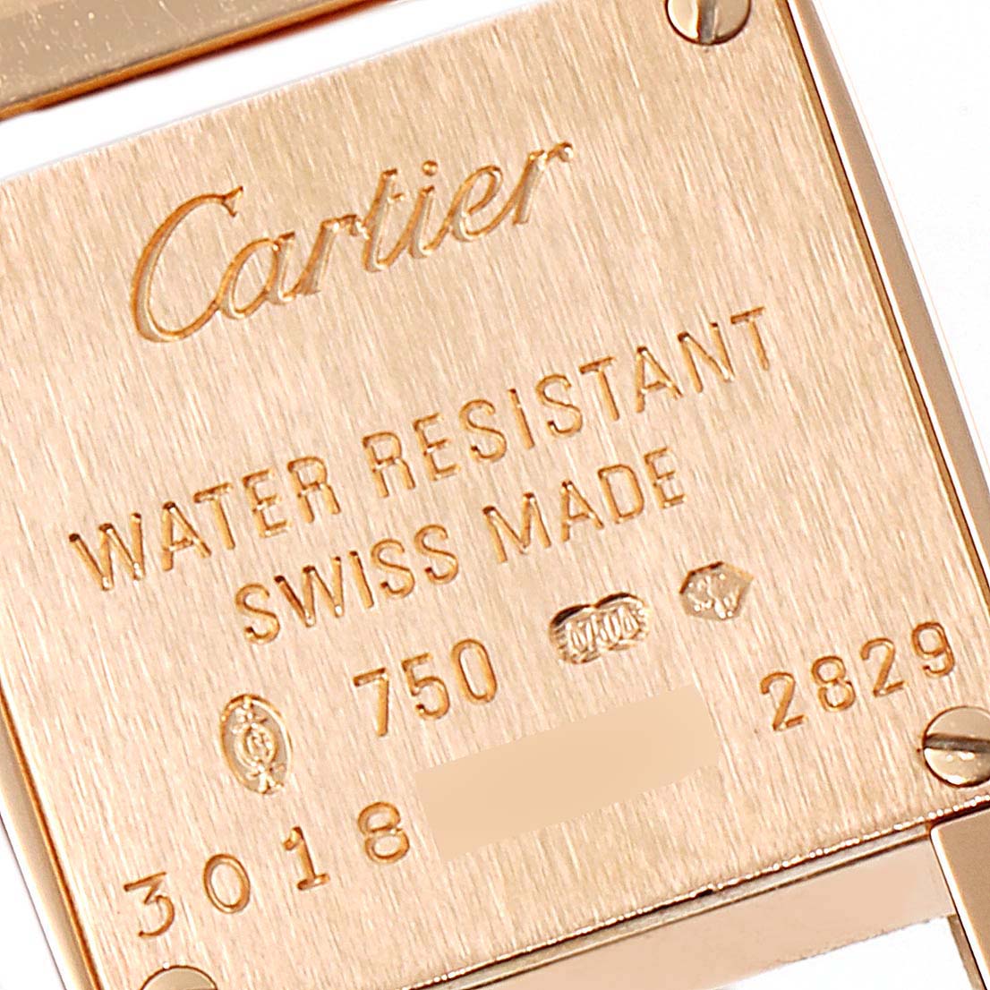 The image shows the back case of a Cartier Tankissime W650018H Women's Rose Gold Silver Dial W650018H Women's Rose Gold Silver Dial watch, highlighting its engravings and hallmark.