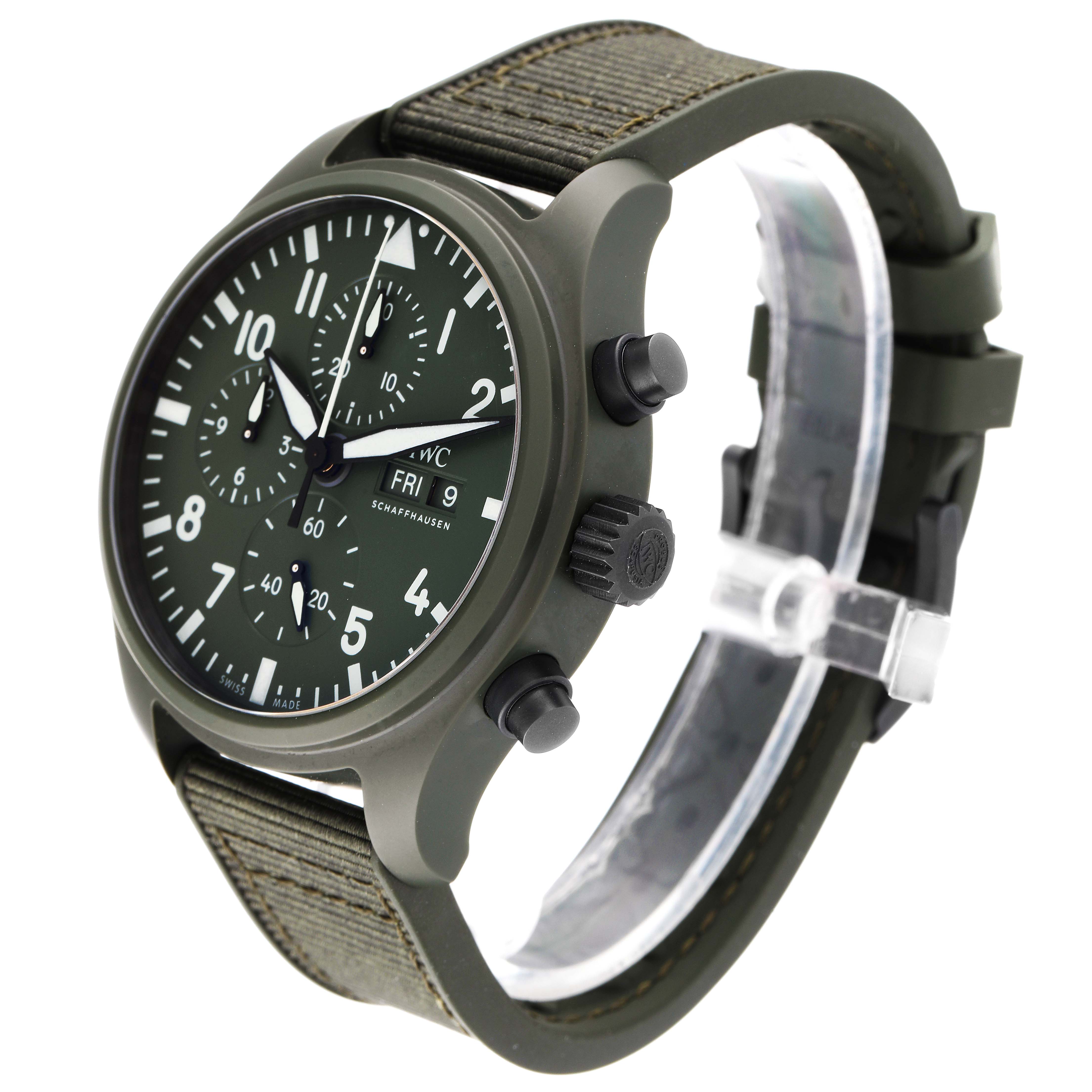 The IWC Pilot IW389106 Men's Ceramic Green Dial IW389106 Men's Ceramic Green Dial watch is shown from a three-quarter angle, displaying its green dial, chronograph, and textile strap.