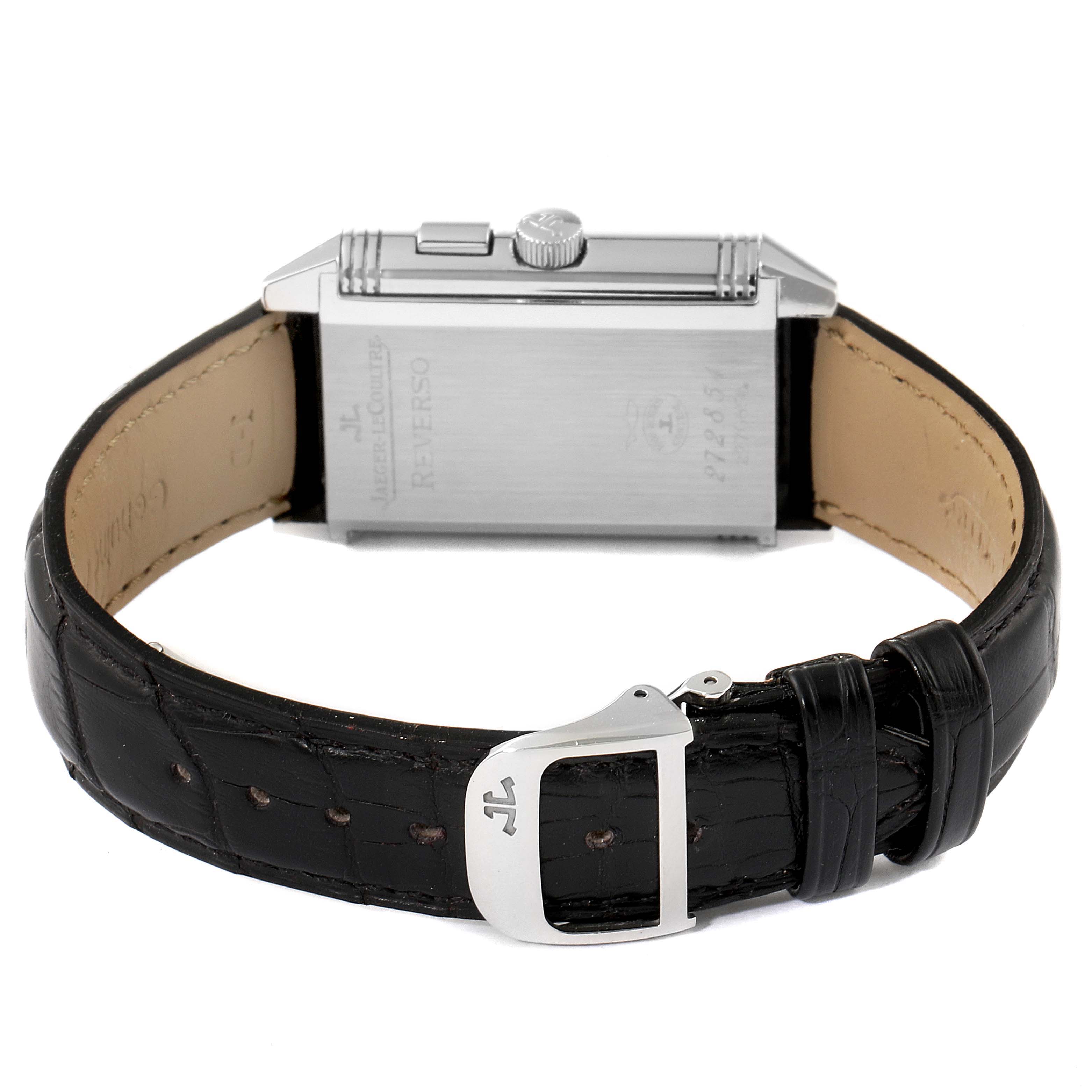 The image shows a Jaeger LeCoultre Reverso Q2718410 Men's Stainless Steel Silver Dial Q2718410 Men's Stainless Steel Silver Dial watch from the back, highlighting its case, crown, and leather strap with buckle.