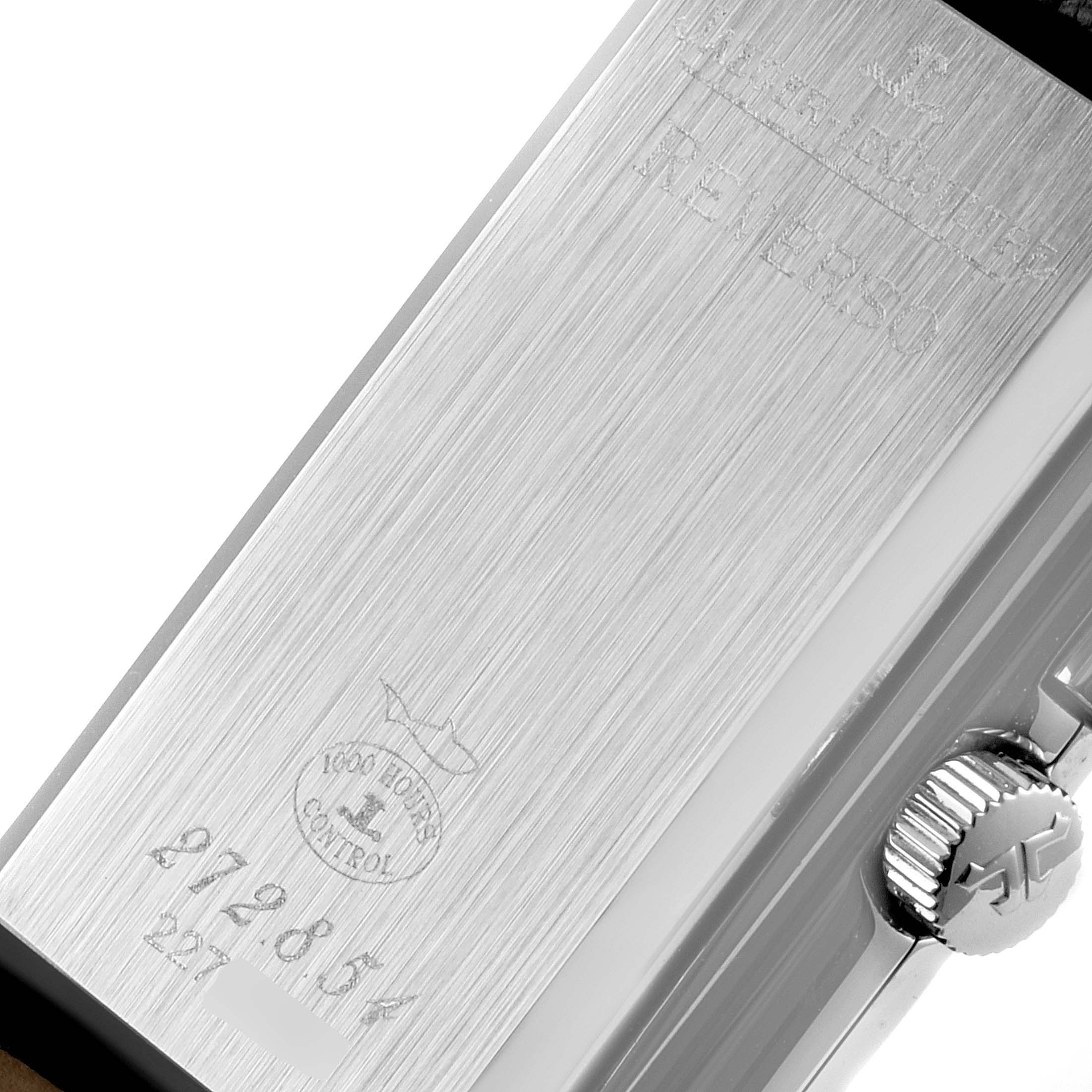 The image shows the engraved case back and crown of a Jaeger-LeCoultre Reverso watch at a close-up angle.