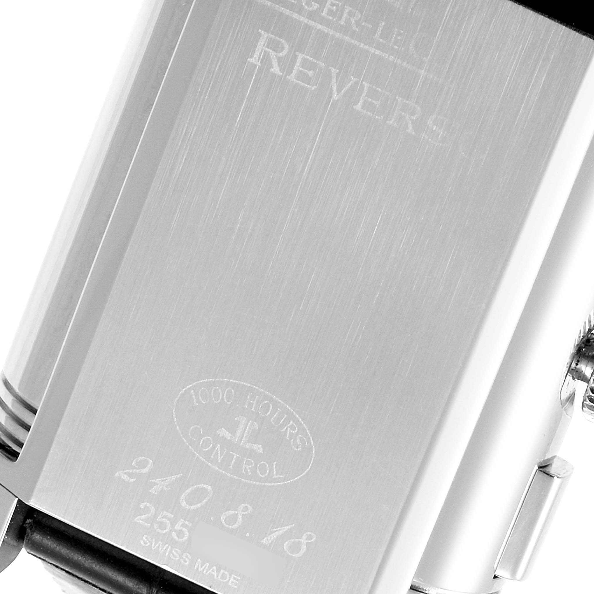 The image shows the engraved back case of the Jaeger-LeCoultre Reverso watch at a close-up angle.
