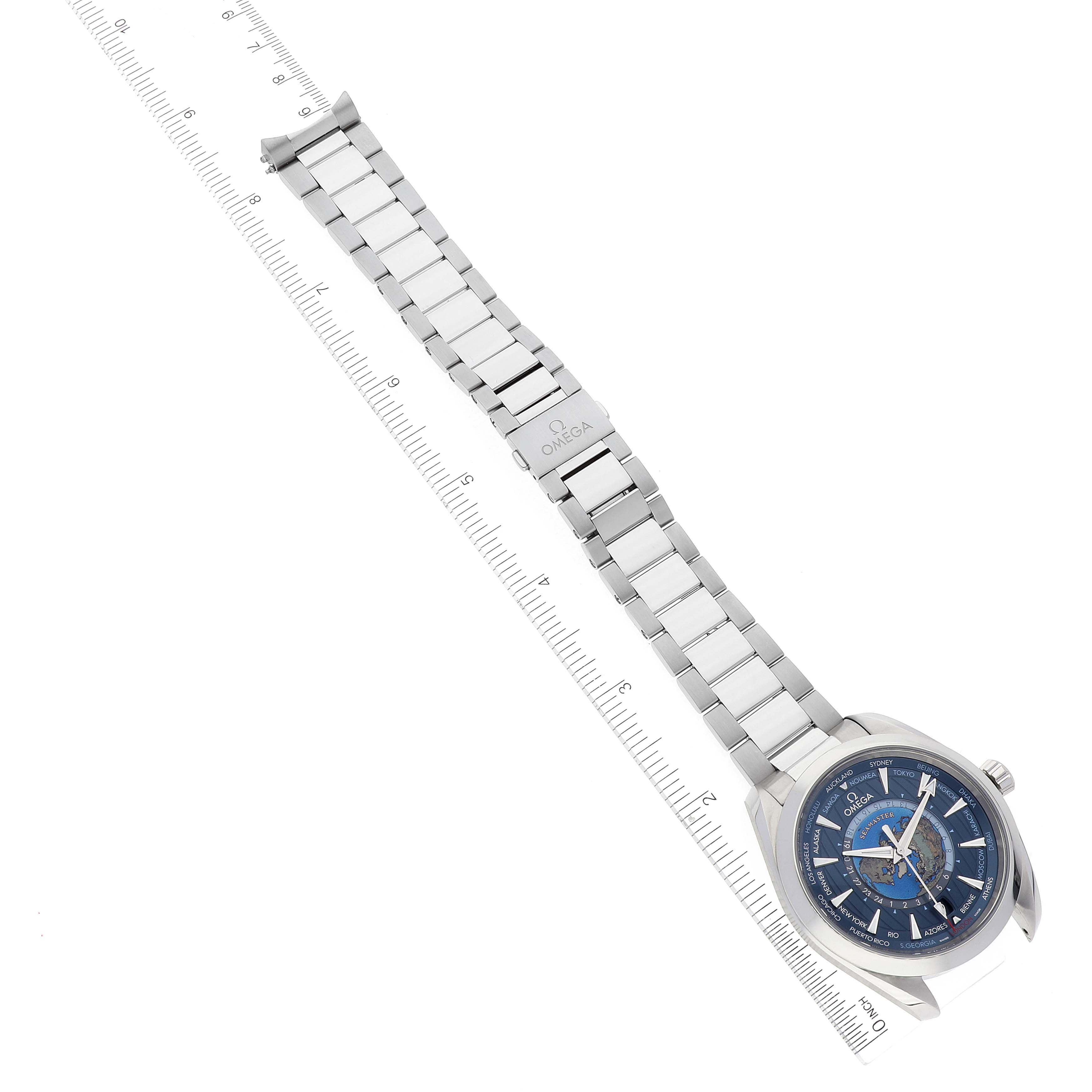 The image shows an Omega Aqua Terra 220.10.43.22.03.001 Men's Stainless Steel Blue Dial 220.10.43.22.03.001 Men's Stainless Steel Blue Dial watch, fully extended with its metal bracelet laid beside a ruler.