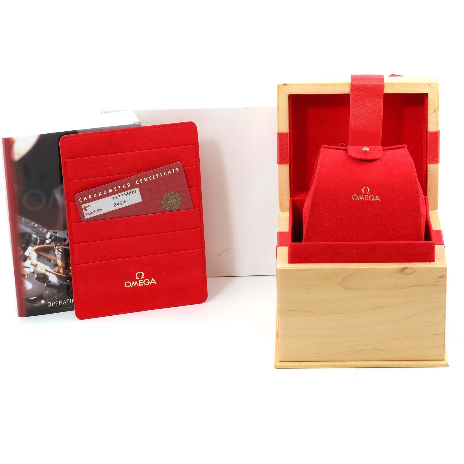 The image shows an Omega Speedmaster 3211.30.00 Men's Stainless Steel Silver Dial 3211.30.00 Men's Stainless Steel Silver Dial box, red cardholder with certification, and operating instructions, all from a front angle.