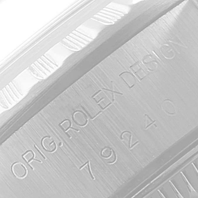 Close-up of the engraved serial number and "ORIG. ROLEX DESIGN" on the case side of a Rolex Date 79240 Women's Stainless Steel Blue Dial 79240 Women's Stainless Steel Blue Dial watch.