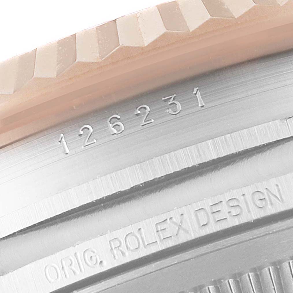 This close-up image shows the engraved reference number and bezel of a Rolex Datejust 126231 Men's Steel and Gold (two tone) White Dial 126231 Men's Steel and Gold (two tone) White Dial model.