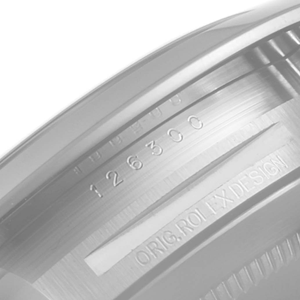 This image shows a close-up of the Rolex Datejust 41 126300 Men
s Stainless Steel Grey Dial 126300 Men
s Stainless Steel Grey Dial model
s inner bezel, featuring the serial number and "ORIG. ROLEX DESIGN" inscription.