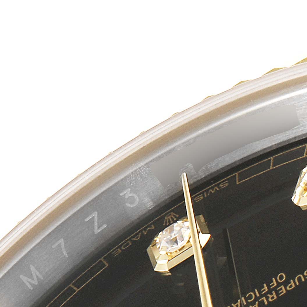 This close-up image shows the bezel, part of the dial, and hour markers of a Rolex Datejust 41 126333 Men's Steel and Gold (two tone) Black Dial 126333 Men's Steel and Gold (two tone) Black Dial watch.