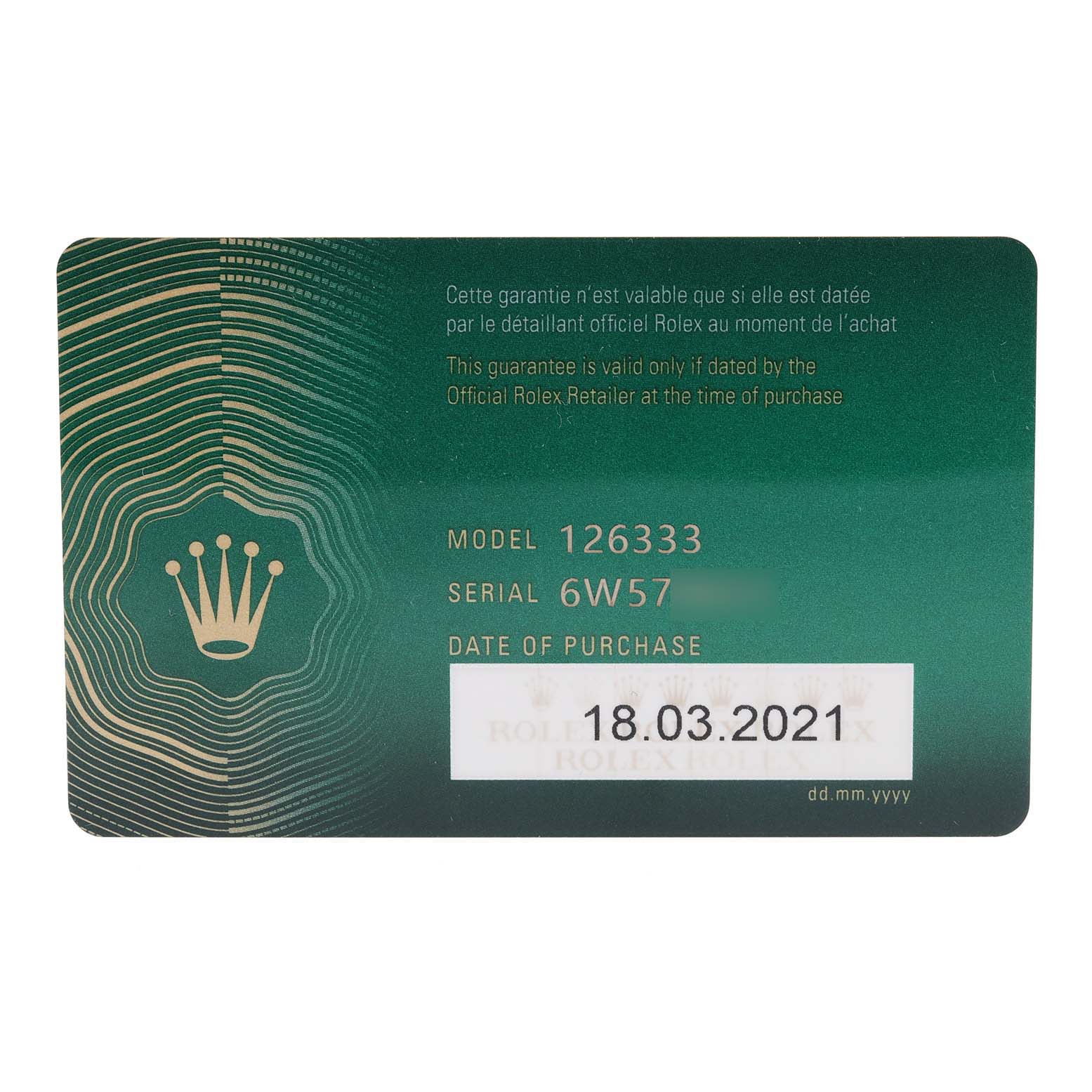 This image shows a green warranty card for the Rolex Datejust 41 126333 Men's Steel and Gold (two tone) Champagne Dial 126333 Men's Steel and Gold (two tone) Champagne Dial model 126333, including the purchase date and serial number.