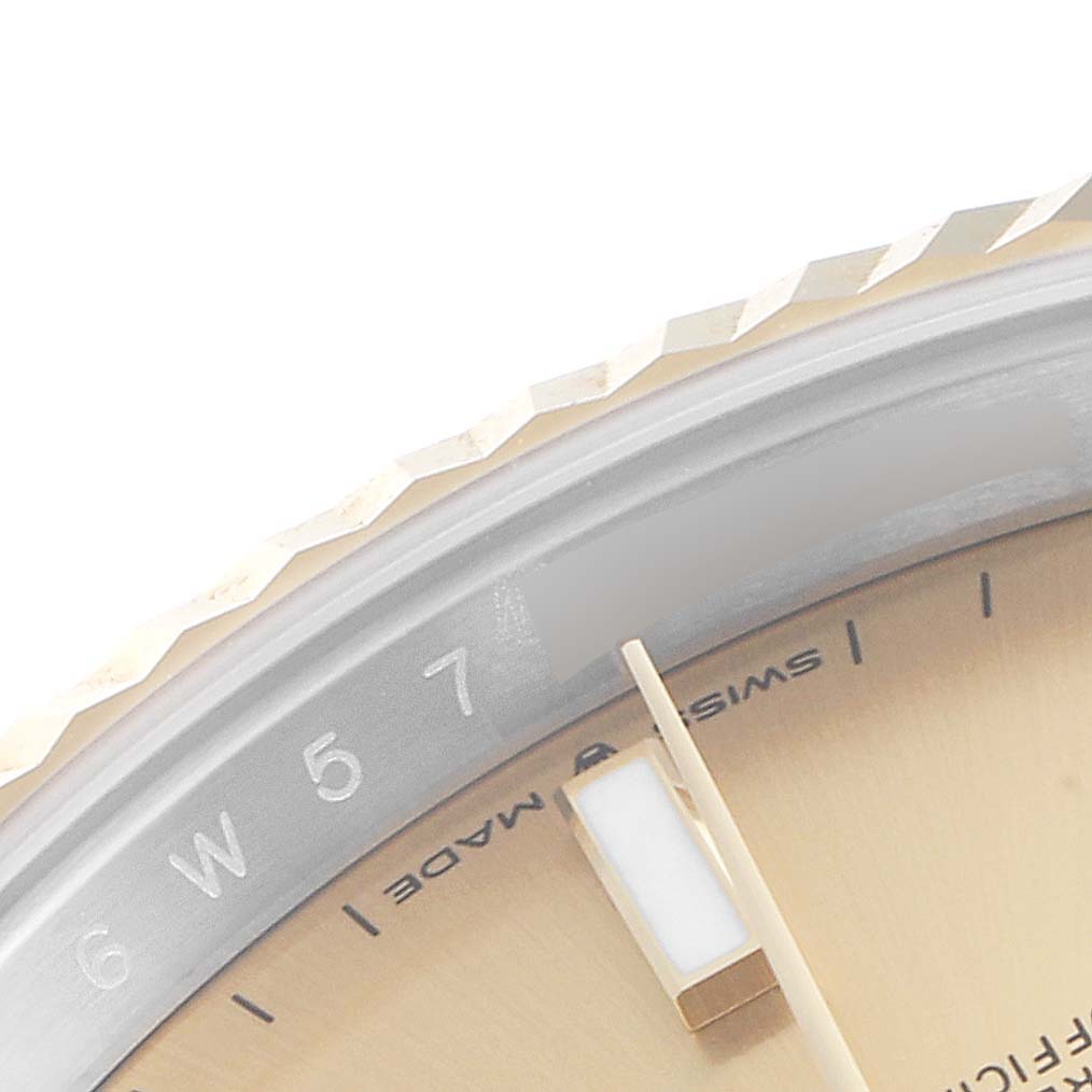 The image shows a close-up of the face, bezel, and part of the dial of a Rolex Datejust 41 126333 Men's Steel and Gold (two tone) Champagne Dial 126333 Men's Steel and Gold (two tone) Champagne Dial watch.