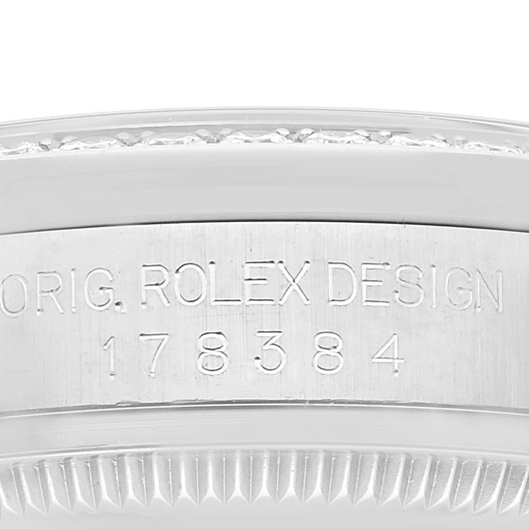 The image shows an up-close view of the engraved side of a mid-size Rolex watch, highlighting the bezel and watch case with the model number 178384.