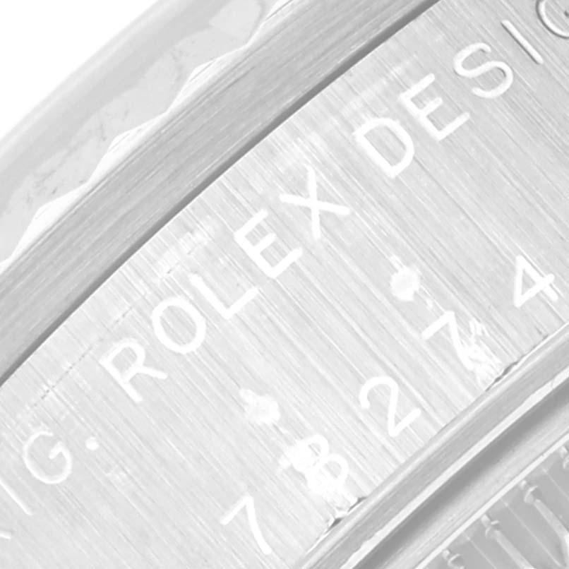 This close-up image shows the engraved lettering on the circumference of a Mid-Size Rolex watch case.