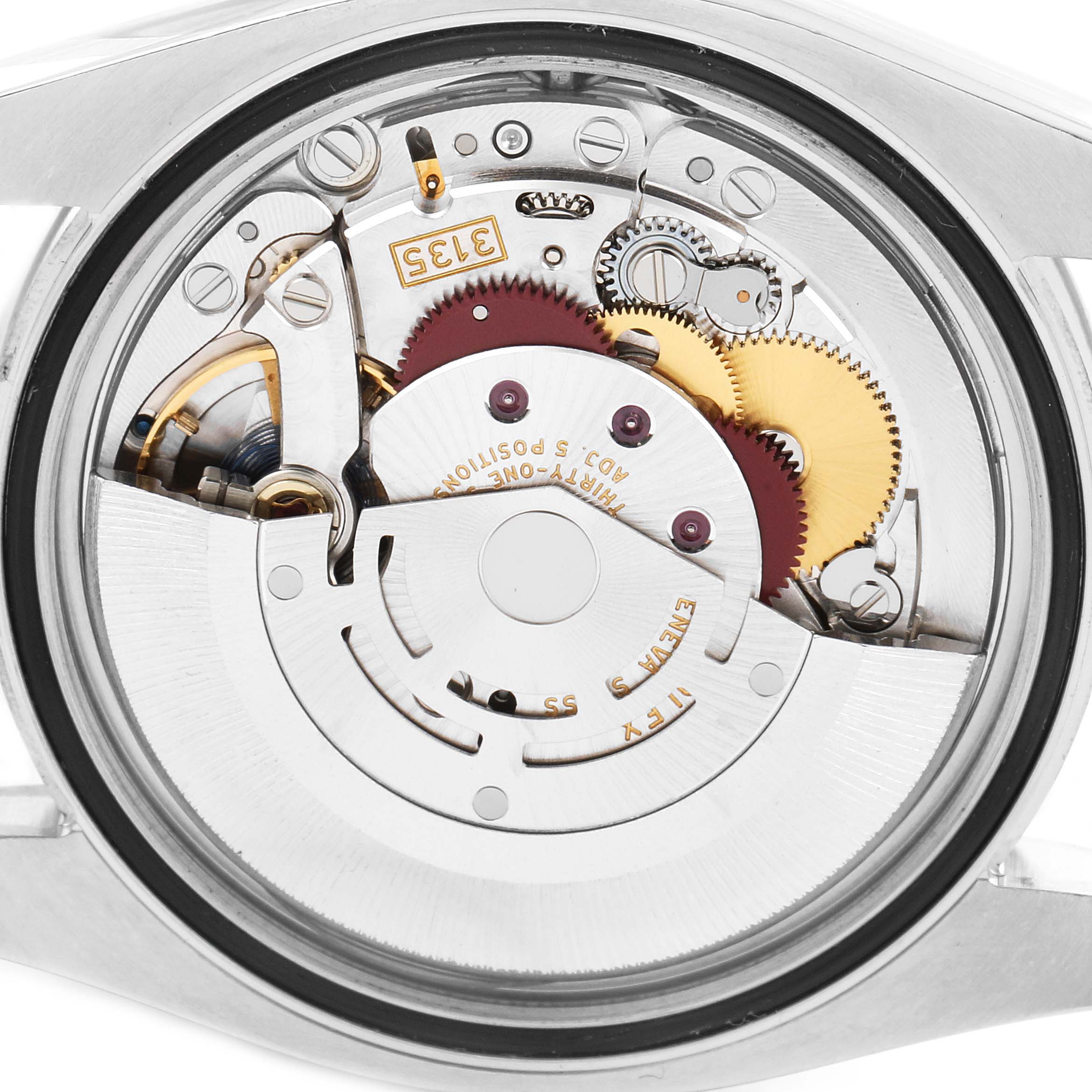 This image shows the internal mechanism of a Rolex Datejust 116234 Men's Stainless Steel Silver Dial 116234 Men's Stainless Steel Silver Dial watch from a rear angle with components like gears and the rotor visible.