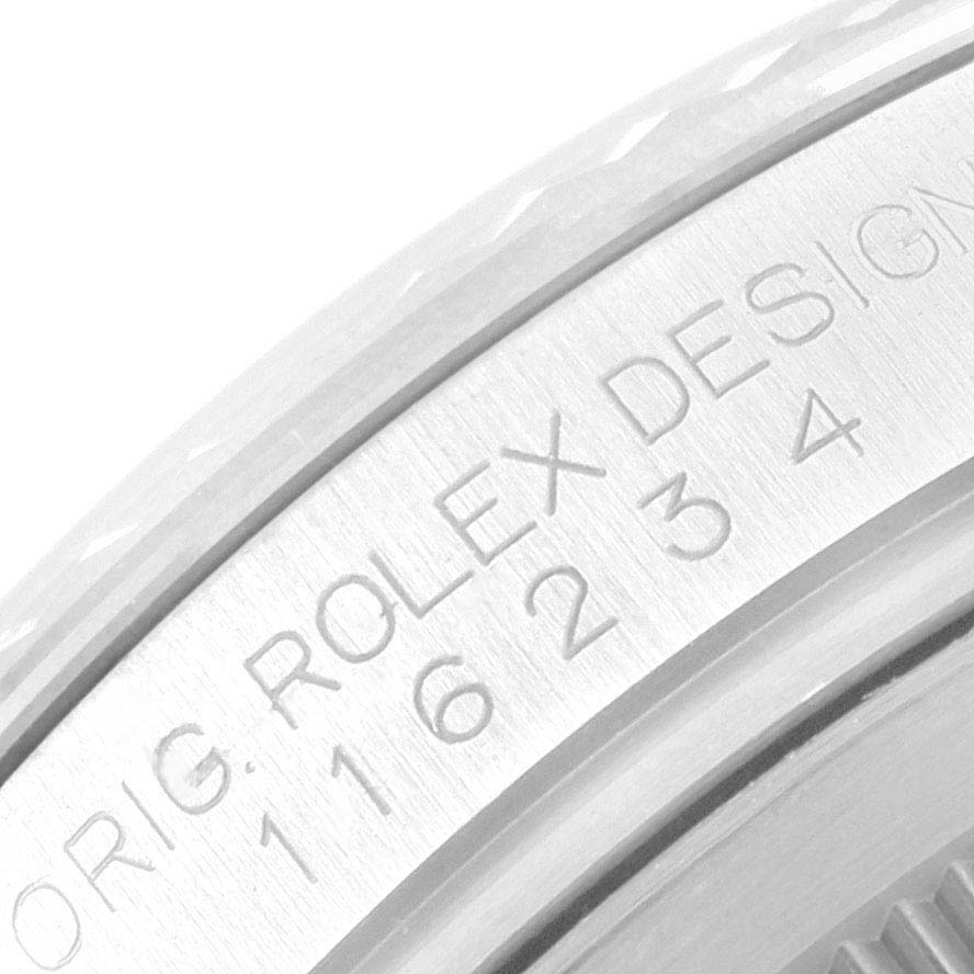 This image shows a close-up of the engraved bezel of a Rolex Datejust 116234 Men's Stainless Steel Silver Dial 116234 Men's Stainless Steel Silver Dial watch, displaying the model number and "Rolex Design" text.