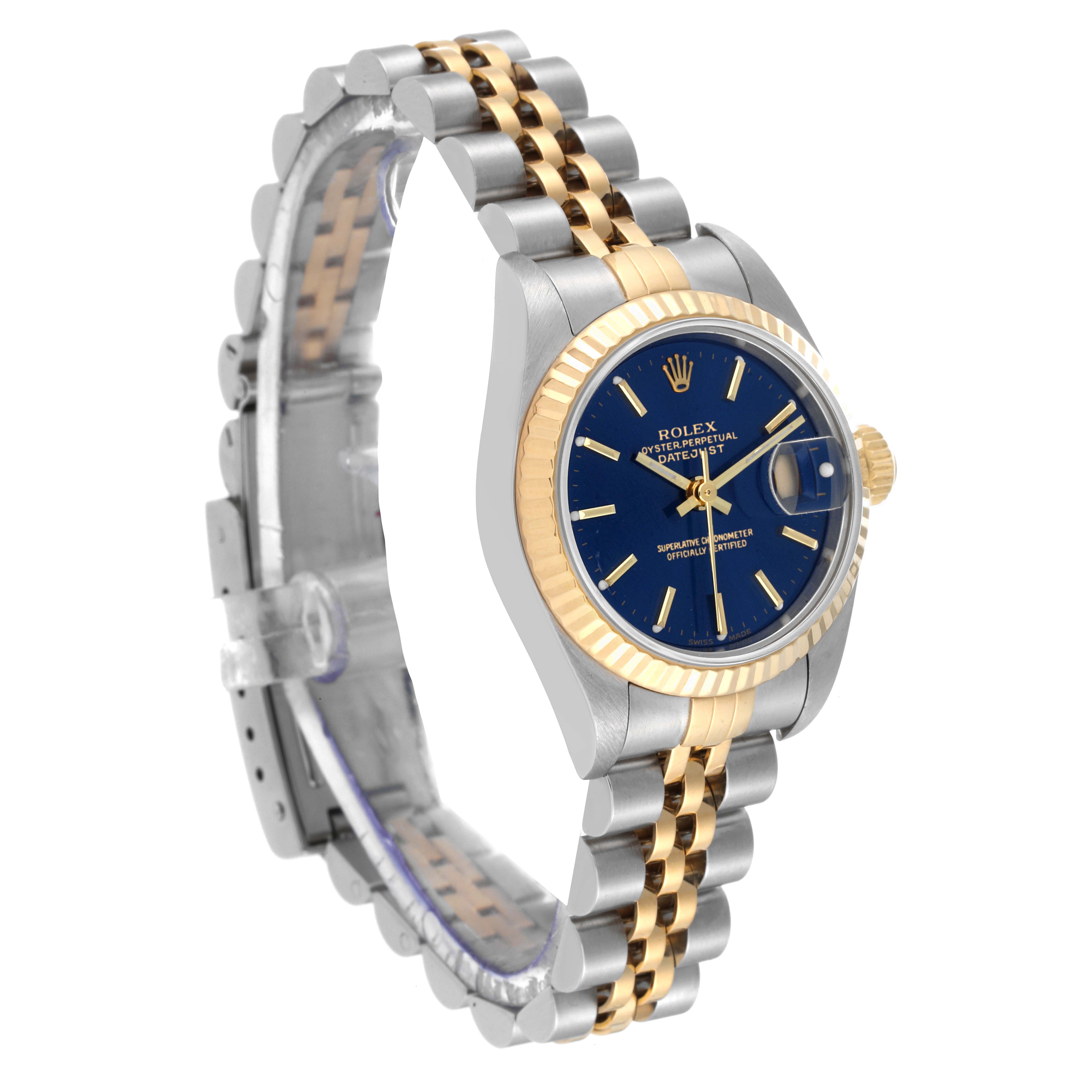 This image shows a Rolex Datejust 79173 Women's Steel and Gold (two tone) Blue Dial 79173 Women's Steel and Gold (two tone) Blue Dial watch at an angle, highlighting its blue dial, fluted bezel, and two-tone metal bracelet.