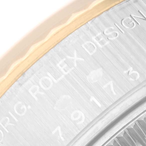 Close-up of the bezel and engraved text on the case of a Rolex Datejust 79173 Women's Steel and Gold (two tone) Blue Dial 79173 Women's Steel and Gold (two tone) Blue Dial watch.